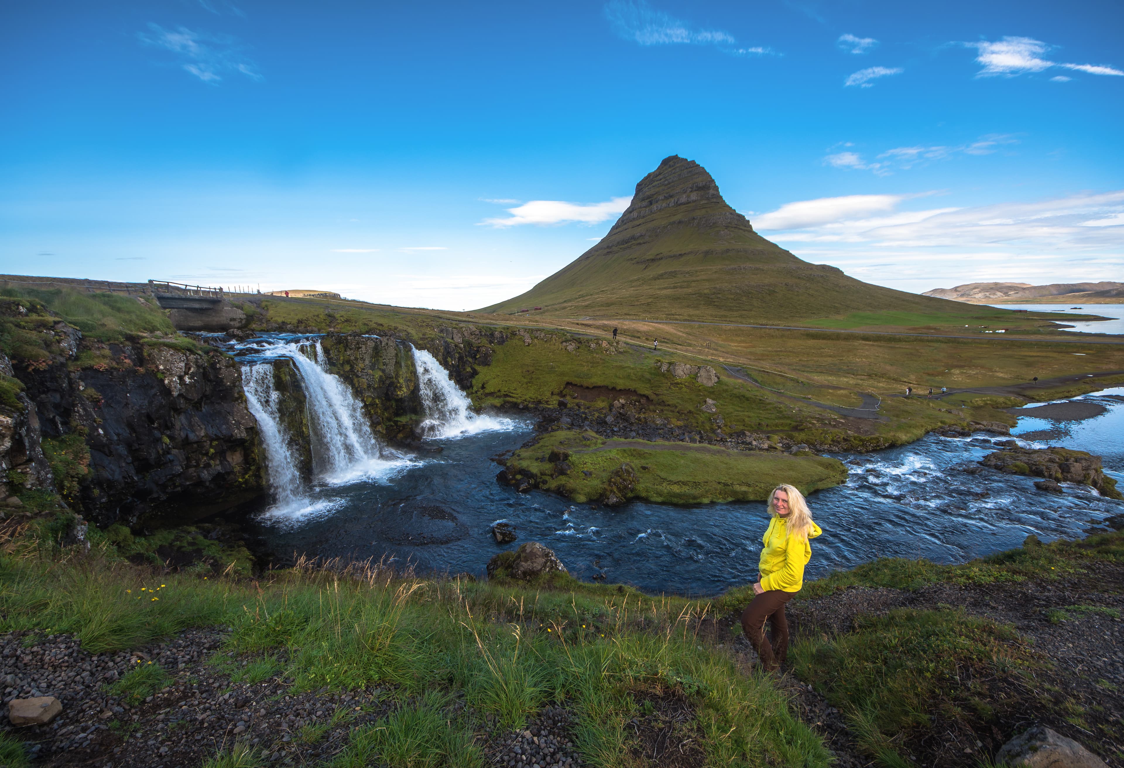Summer sunset over the famous Kirkjufellsfoss Waterfall with Kirkjufell mountain in the background in Iceland. Long exposure. Summer sunset over the famous Kirkjufellsfoss Waterfall
