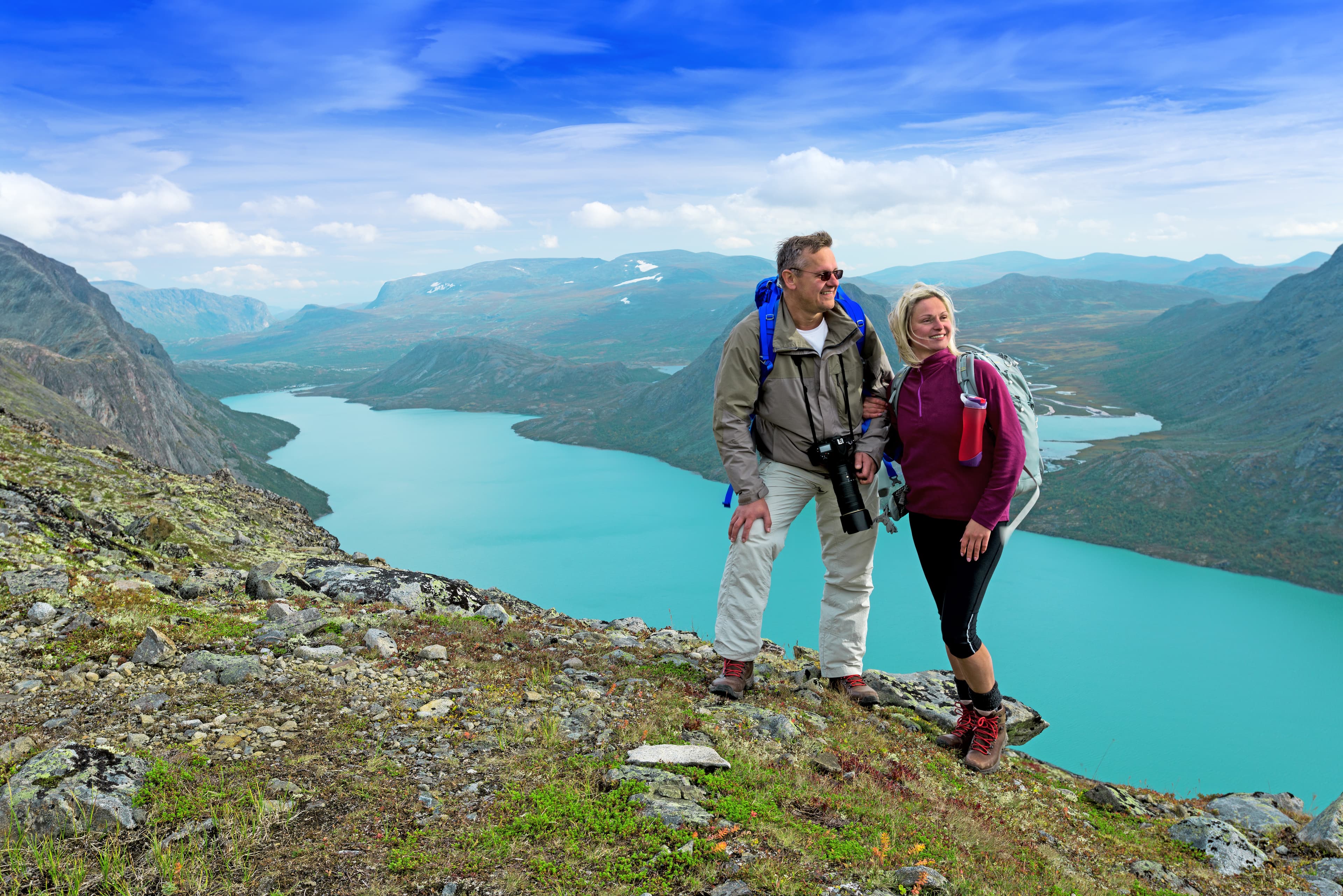 Happy backpackers at Besseggen ridge at Jotunheimen national park, Norway Backpackers at Besseggen ridge at Jotunheimen national park