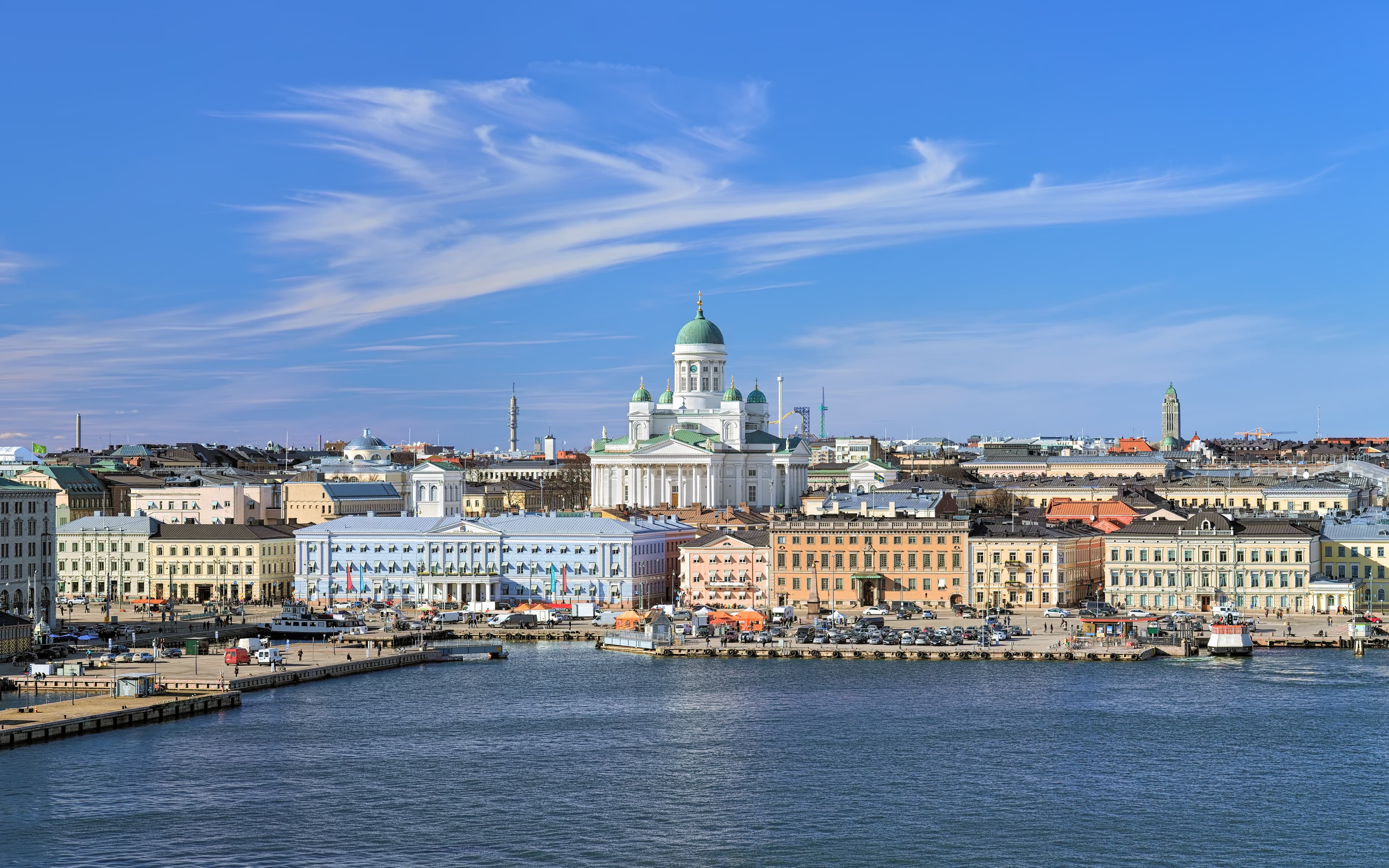 Helsinki, Finland. Scenic cityscape with Helsinki Cathedral, South Harbor, Market Square (Kauppatori) and beautiful cirrus clouds over them in the sunny spring day. Cityscape of Helsinki with Cathedral, South Harbor and Market Square, Finland