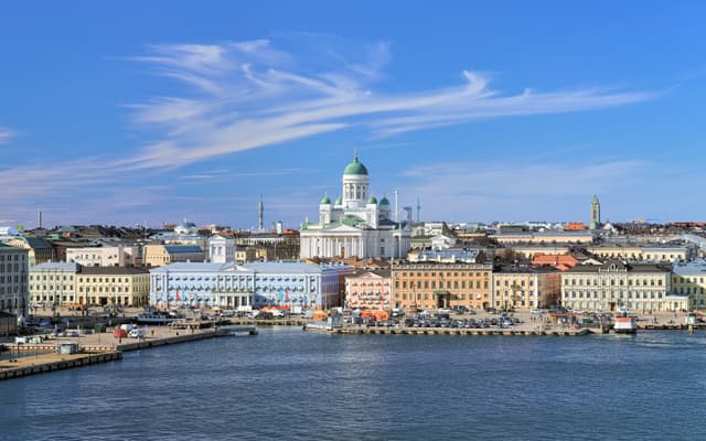 Helsinki, Finland. Scenic cityscape with Helsinki Cathedral, South Harbor, Market Square (Kauppatori) and beautiful cirrus clouds over them in the sunny spring day. Cityscape of Helsinki with Cathedral, South Harbor and Market Square, Finland