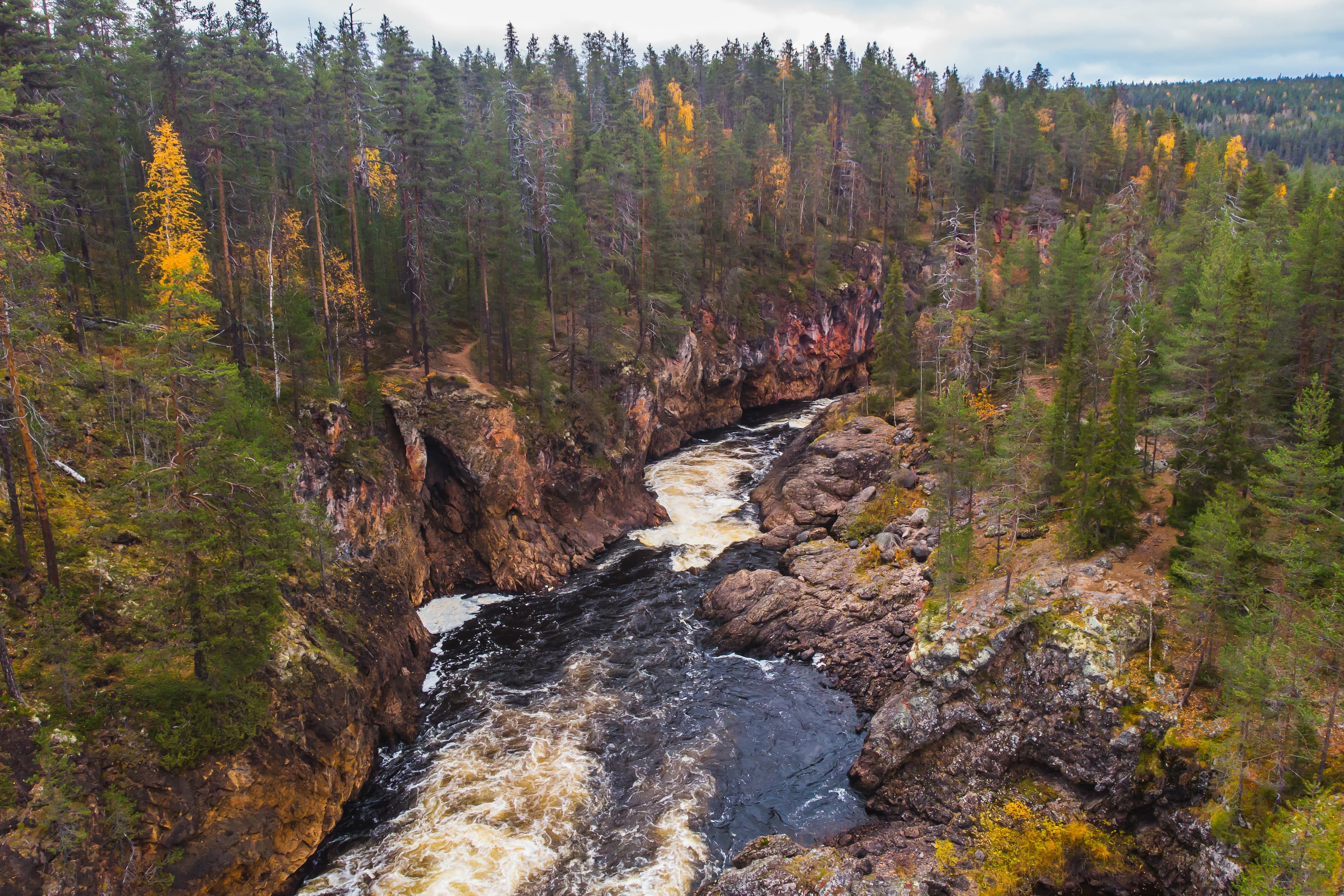Autumn view of Oulanka National Park, landscape, a finnish national park in the Northern Ostrobothnia and Lapland regions of Finland,  wooden wilderness hut, cabin cottage, bridge, campground Autumn view of Oulanka National Park, landscape, a finnish national park in the Northern Ostrobothnia and Lapland regions of Finland,  wooden wilderness hut, cabin cottage, bridge, campground place