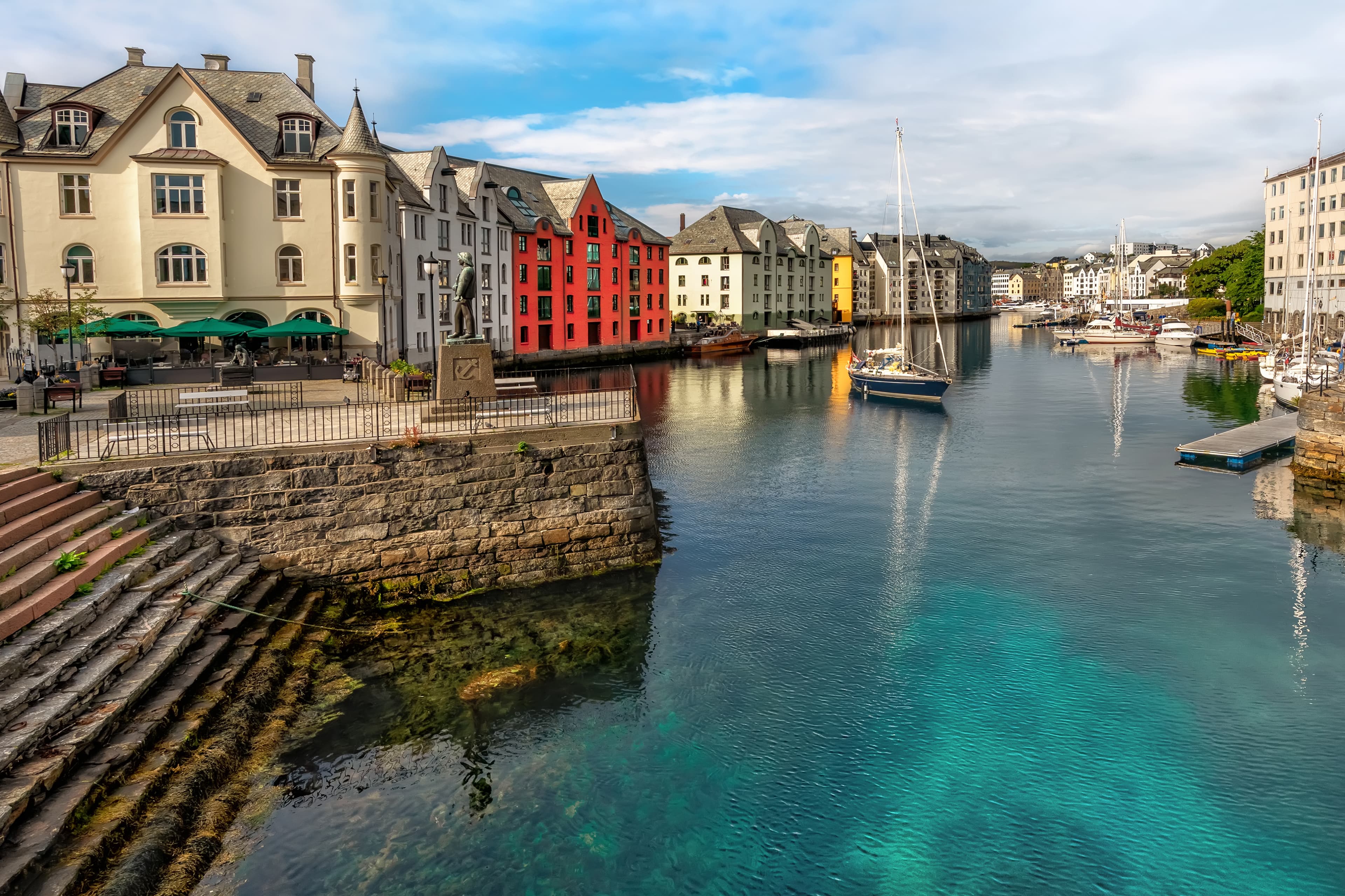 Great summer view of Alesund port town on the west coast of Norway, at the entrance to the Geirangerfjord. Old architecture of Alesund town in city centre. Great summer view of Alesund port town on the west coast of Norway