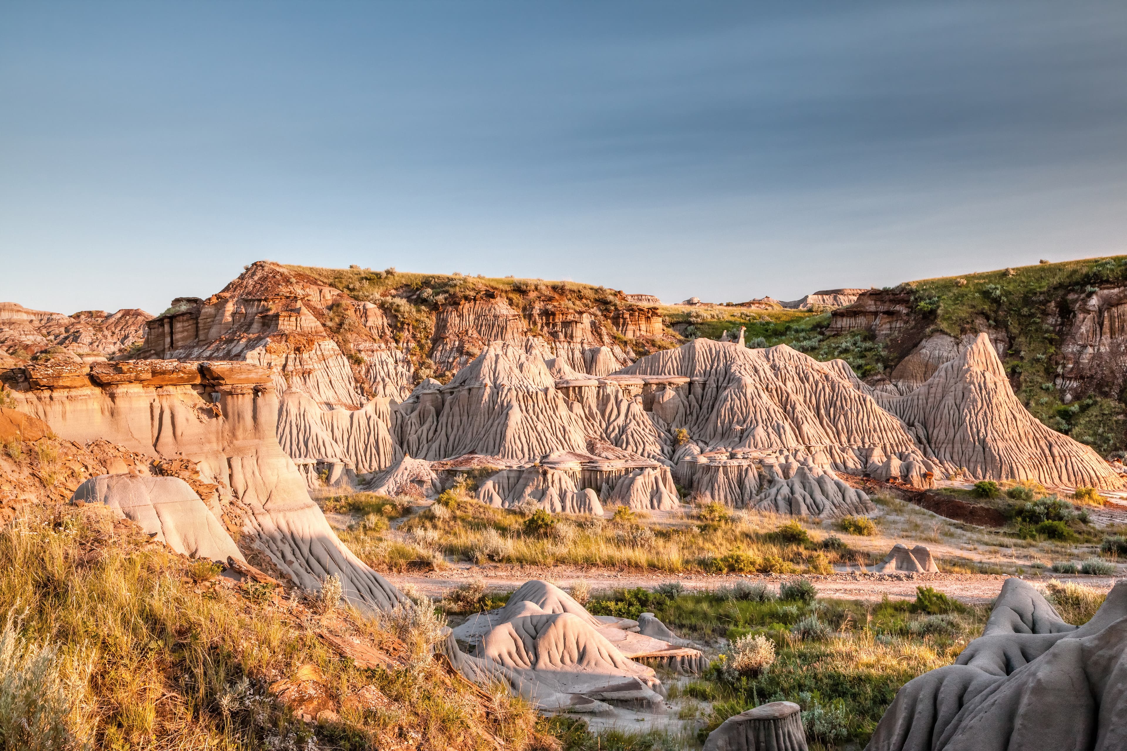 Sun setting over Dinosaur Provincial Park, a UNESCO World Heritage Site in Alberta, Canada. The Alberta badlands is well known for being one of the richest dinosaur fossil locales in the world. Badlands of Dinosaur Provincial Park in Alberta, Canada