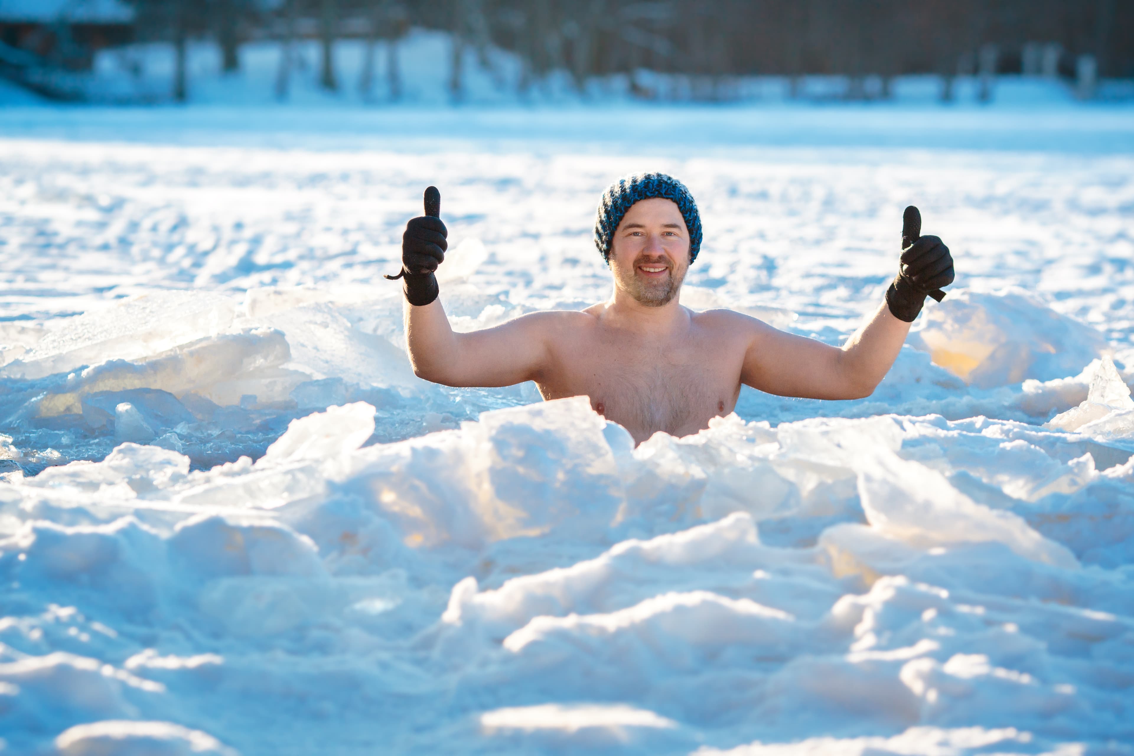 Winter swimming in frozen lake. Man in an ice-hole. Healthy lifestyle Winter swimming. Brave man in an ice-hole