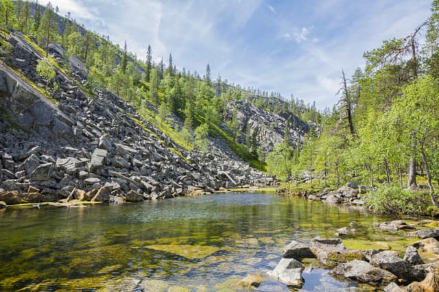 View of The Pyha-Luosto National Park in summer, rocks, stones, trees and natural pond, Lapland, Finland