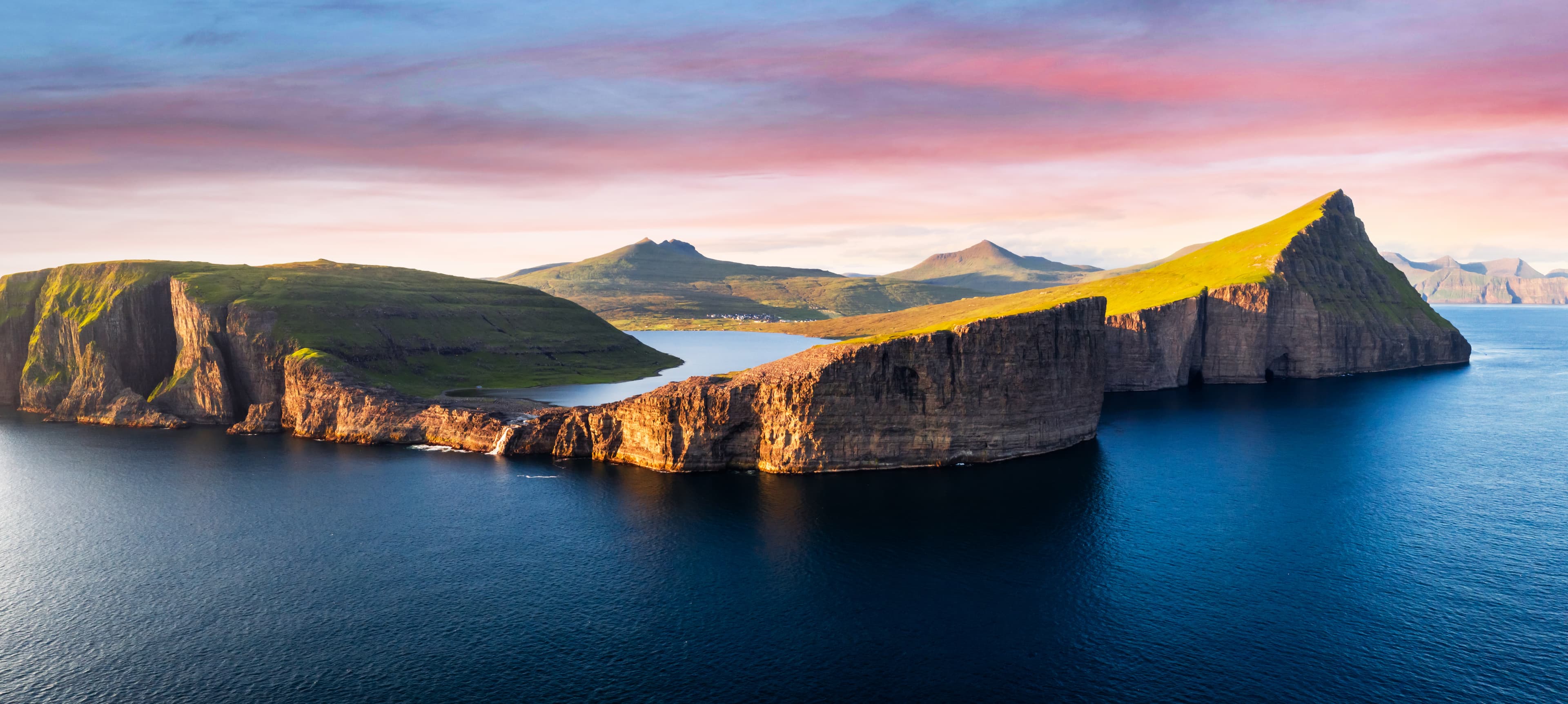 Aerial view from drone of Sorvagsvatn lake on cliffs of Vagar island in sunset time, Faroe Islands, Denmark. Landscape photography panorama Sorvagsvatn lake on cliffs of Vagar island in sunset, Faroe Islands