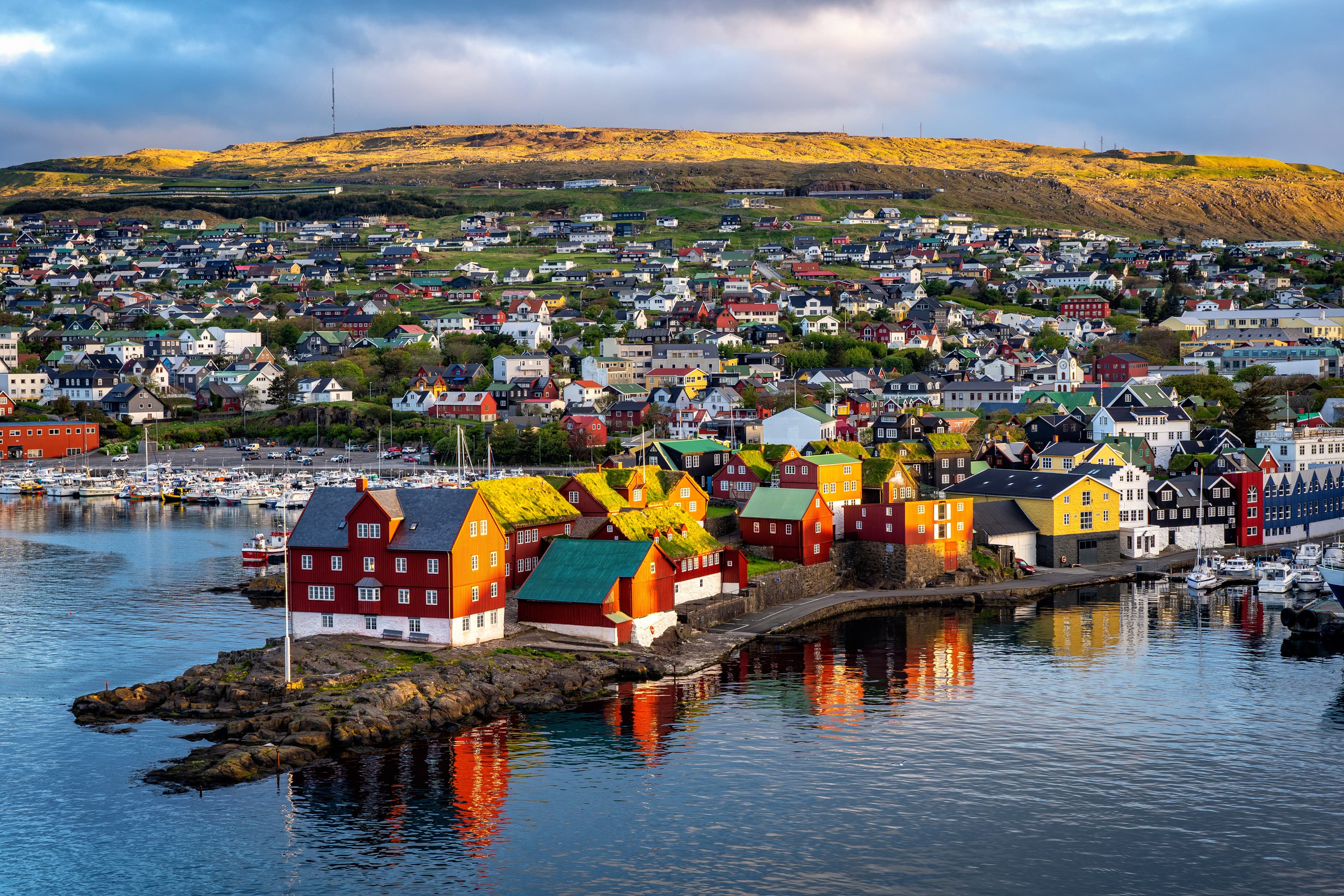 Sunrise scene of capital city Torshavn in Faroe Islands in North Atlantic. Urban scene of scandinavian city in warm golden sunlight. Torshavn is capital of faroe islands in north atlantic.