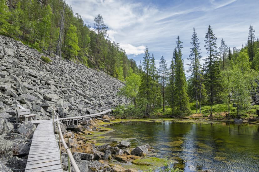 View of The Pyha-Luosto National Park in summer, rocks, stones, trees, wooden walkway and natural pond, Lapland, Finland View of The Pyha-Luosto National Park in summer, rocks, stones, trees, wooden walkway and natural pond, Lapland, Finland