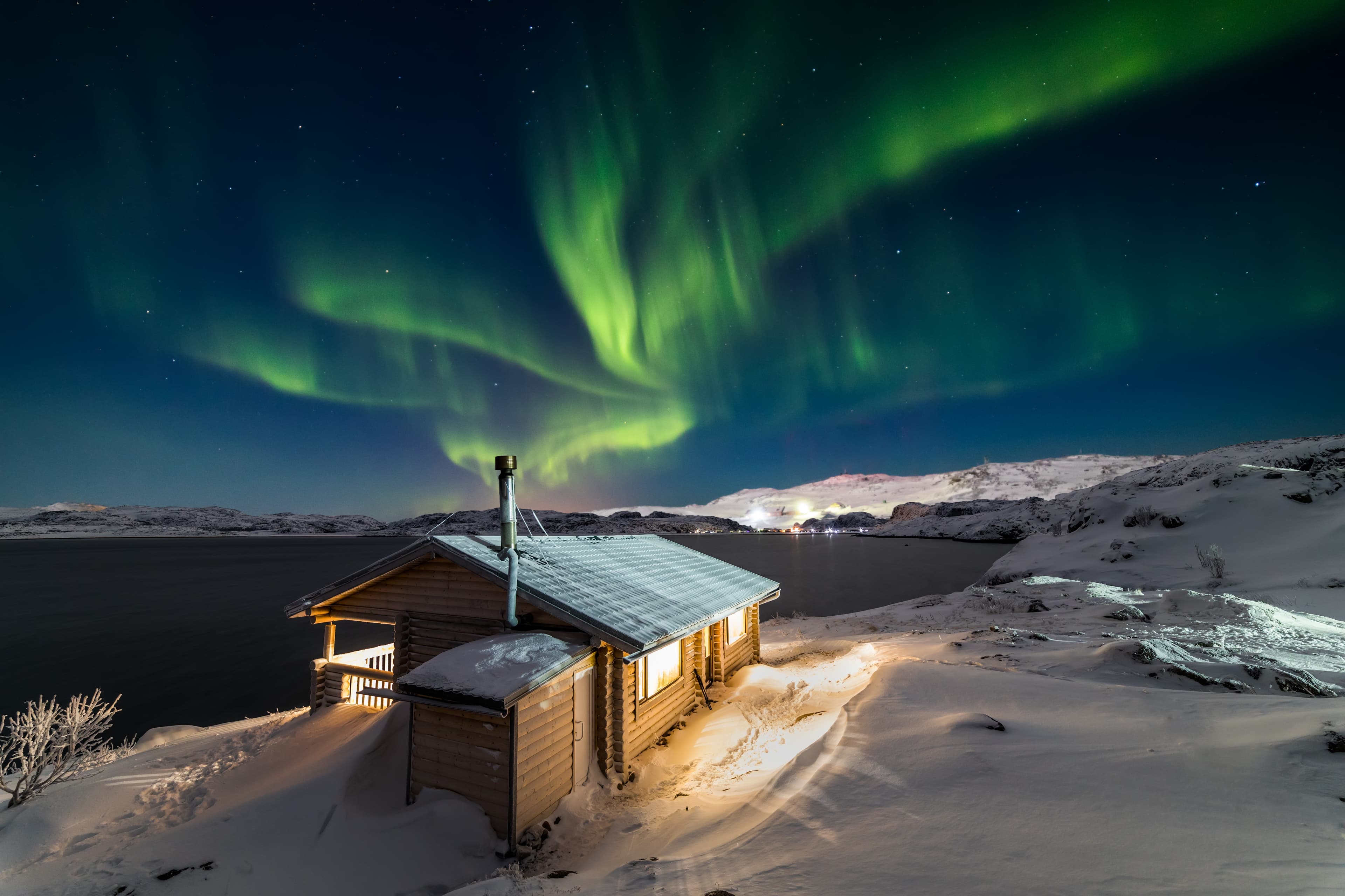 Wooden cottage on the background of the Northern Lights at night Wooden cottage on the background of the Northern Lights at night.