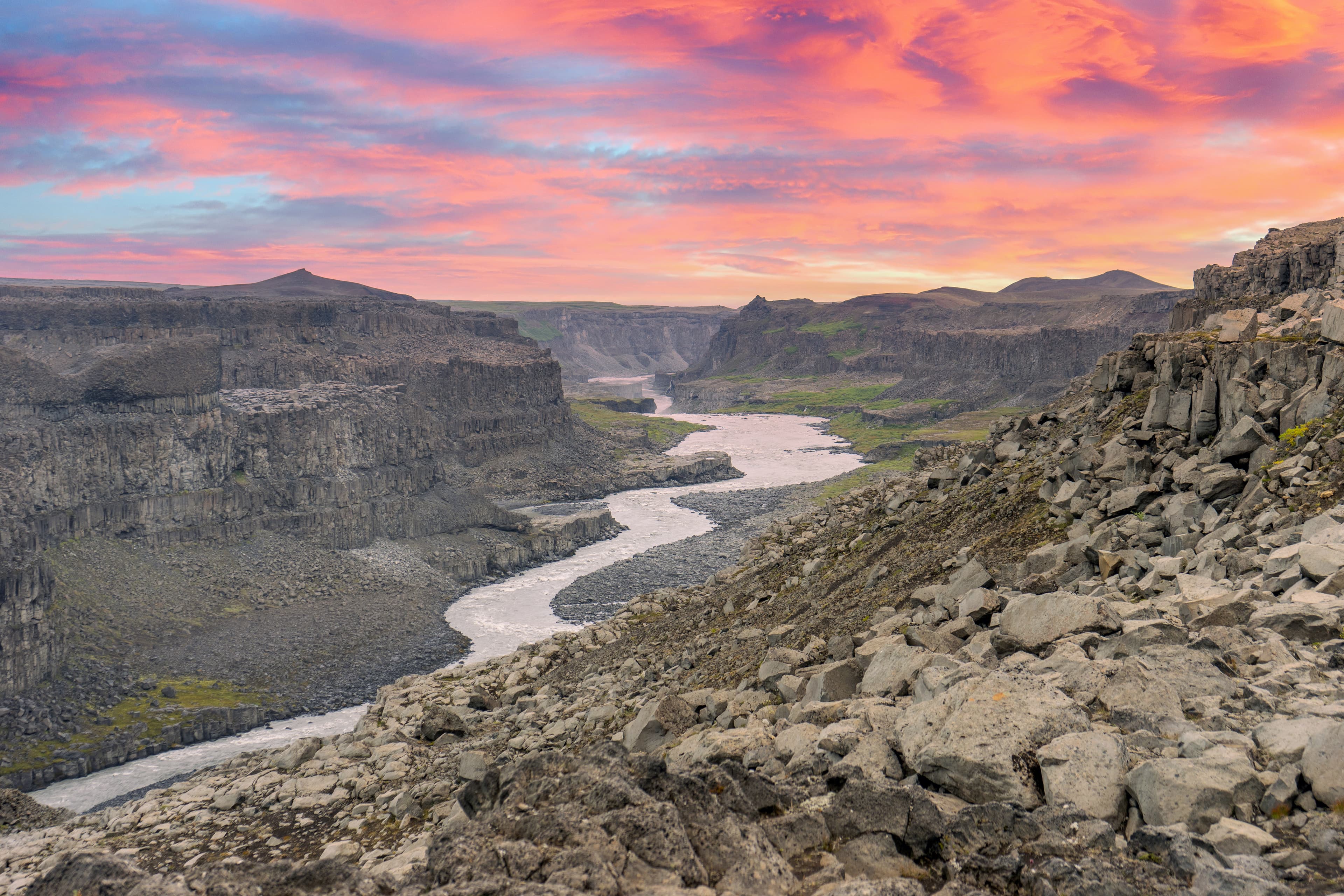 Jokulsa a fjollum river in the highlands of Iceland with pink skies during evening. Area covered with volcanic rocks and basalt columns. Travelling and holiday concept. Jokulsa a fjollum river in the highlands of Iceland with pink skies during evening. Area covered with volcanic rocks and basalt columns. Travelling and holiday concept.