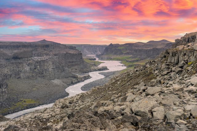 Jokulsa a fjollum river in the highlands of Iceland with pink skies during evening. Area covered with volcanic rocks and basalt columns. Travelling and holiday concept. Jokulsa a fjollum river in the highlands of Iceland with pink skies during evening. Area covered with volcanic rocks and basalt columns. Travelling and holiday concept.
