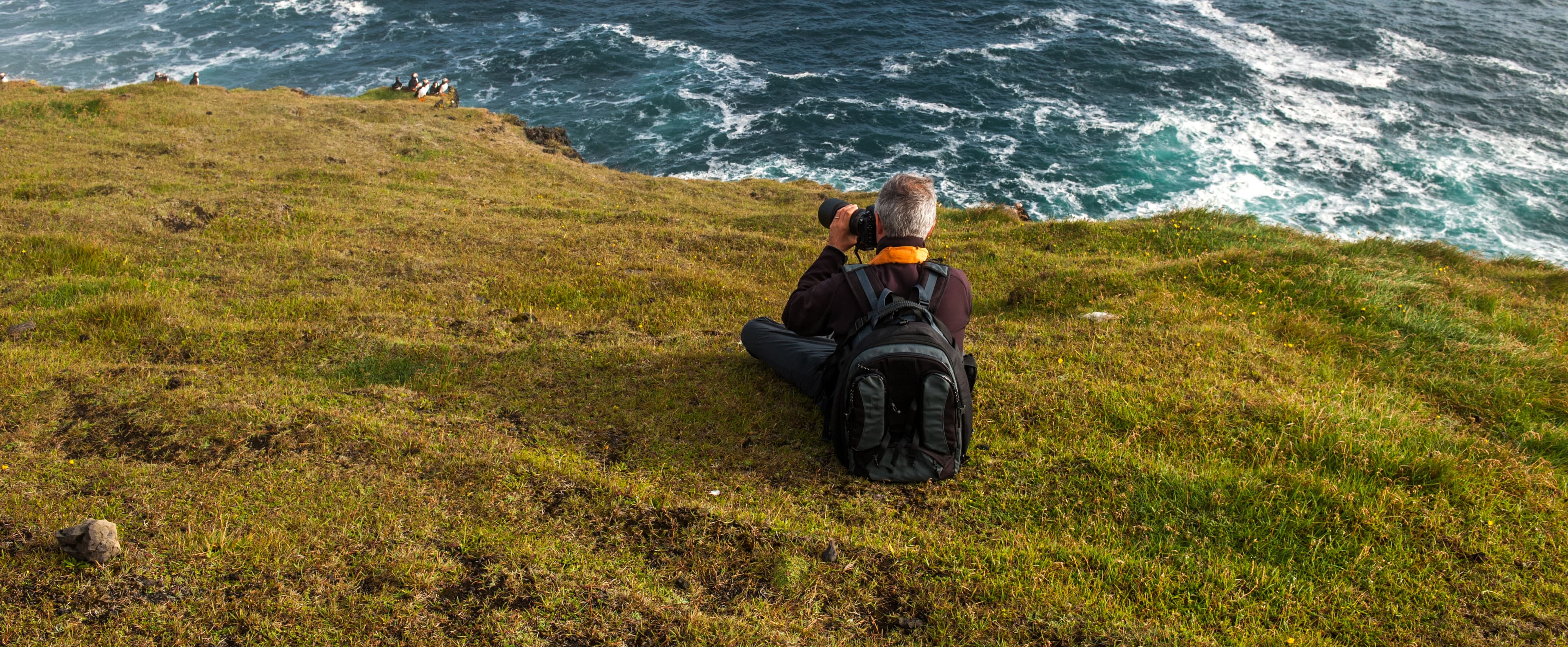 Photographer in Heimaey coast, South Iceland