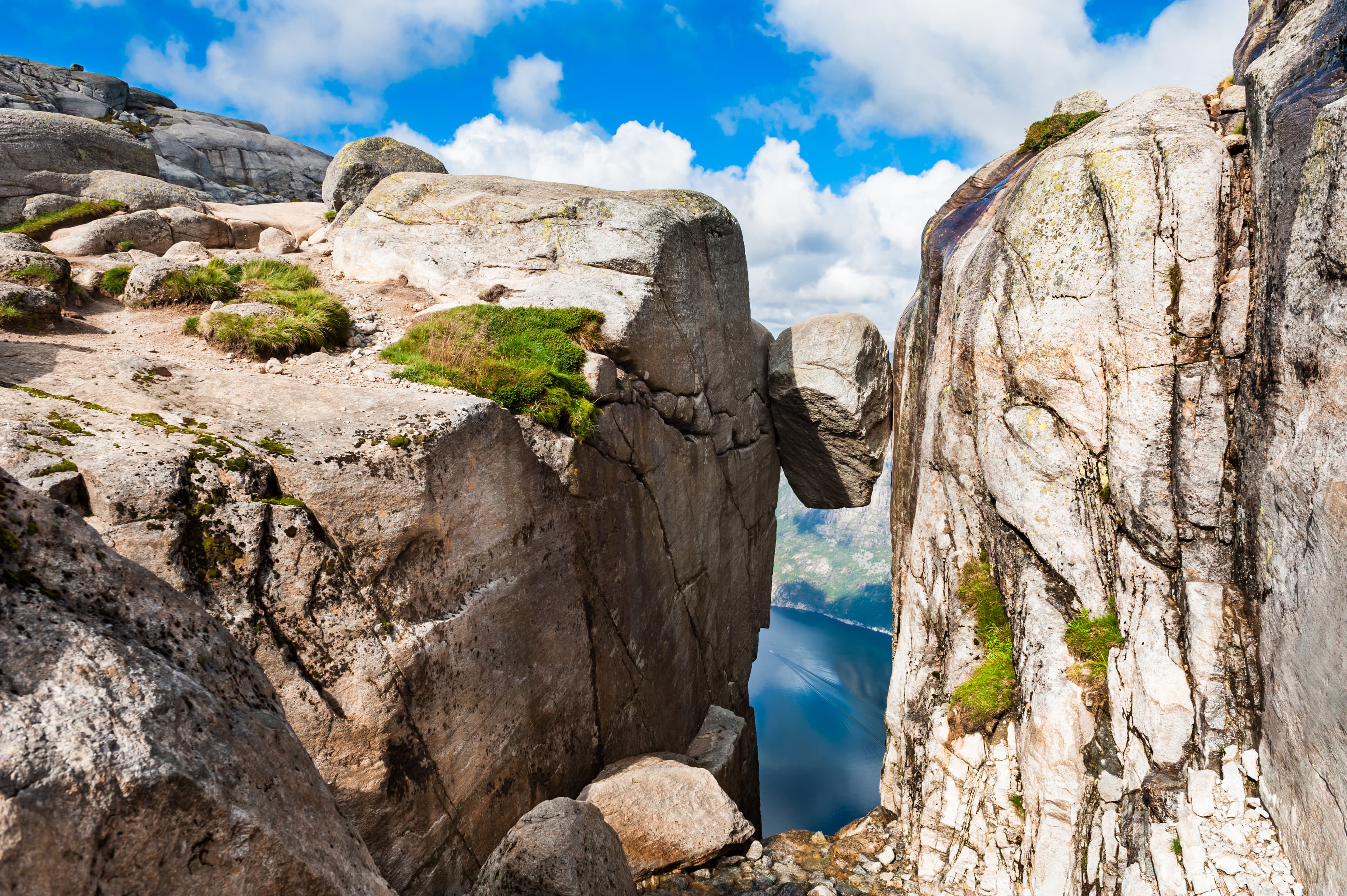 Kjeragbolten - famous landmark on Kjerag mountain, Norway. Summer landscape Kjeragbolten - famous landmark on Kjerag mountain, Norway.