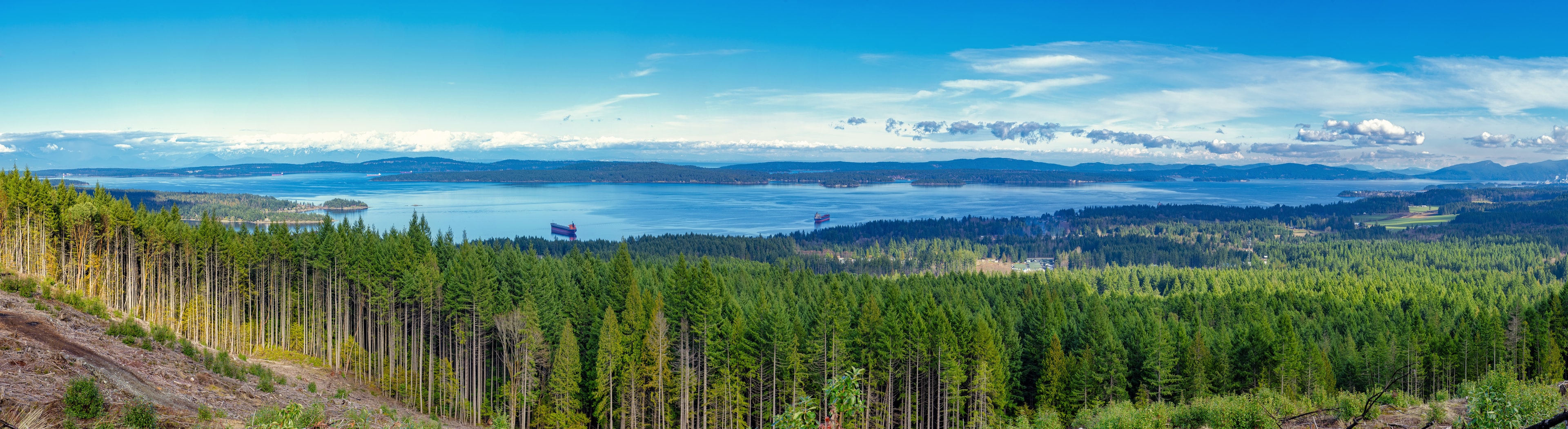 Panoramic view of Ladysmith shoreline from top of a mountain and gulf islands in the horizon, taken on Vancouver Island, BC, Canada British Columbia Region 09