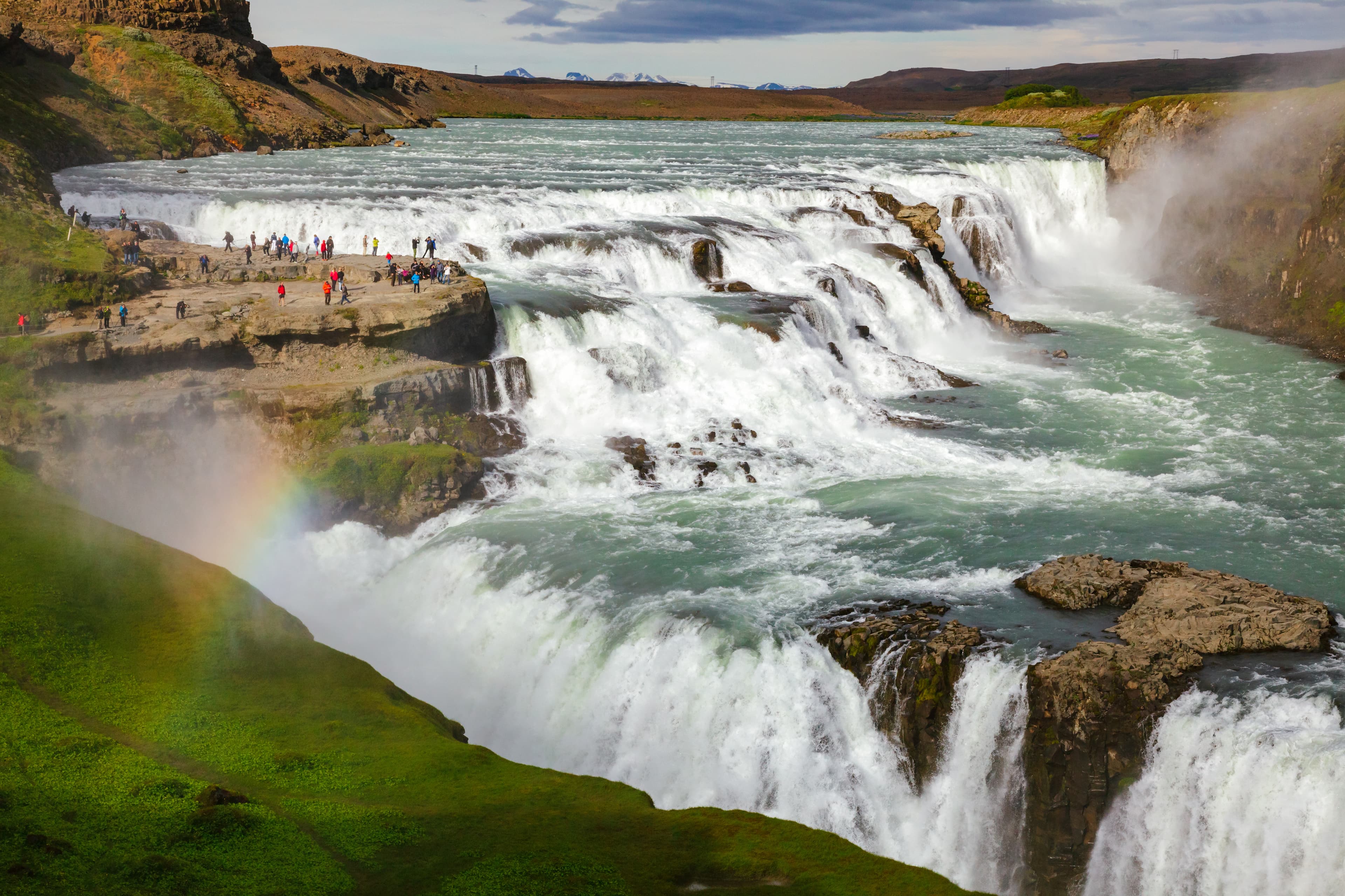 Tourists at the Gullfoss (Golden Falls) waterfall on the Hvítá river, a popular tourist attraction and part of the Golden Circle Tourist Route in Southwest Iceland, Scandinavia Gullfoss waterfall Hvita river Southwest Iceland Scandinavia