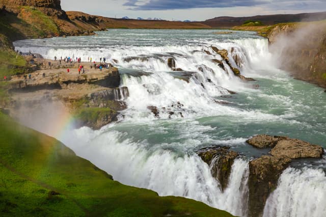 Tourists at the Gullfoss (Golden Falls) waterfall on the Hvítá river, a popular tourist attraction and part of the Golden Circle Tourist Route in Southwest Iceland, Scandinavia Gullfoss waterfall Hvita river Southwest Iceland Scandinavia