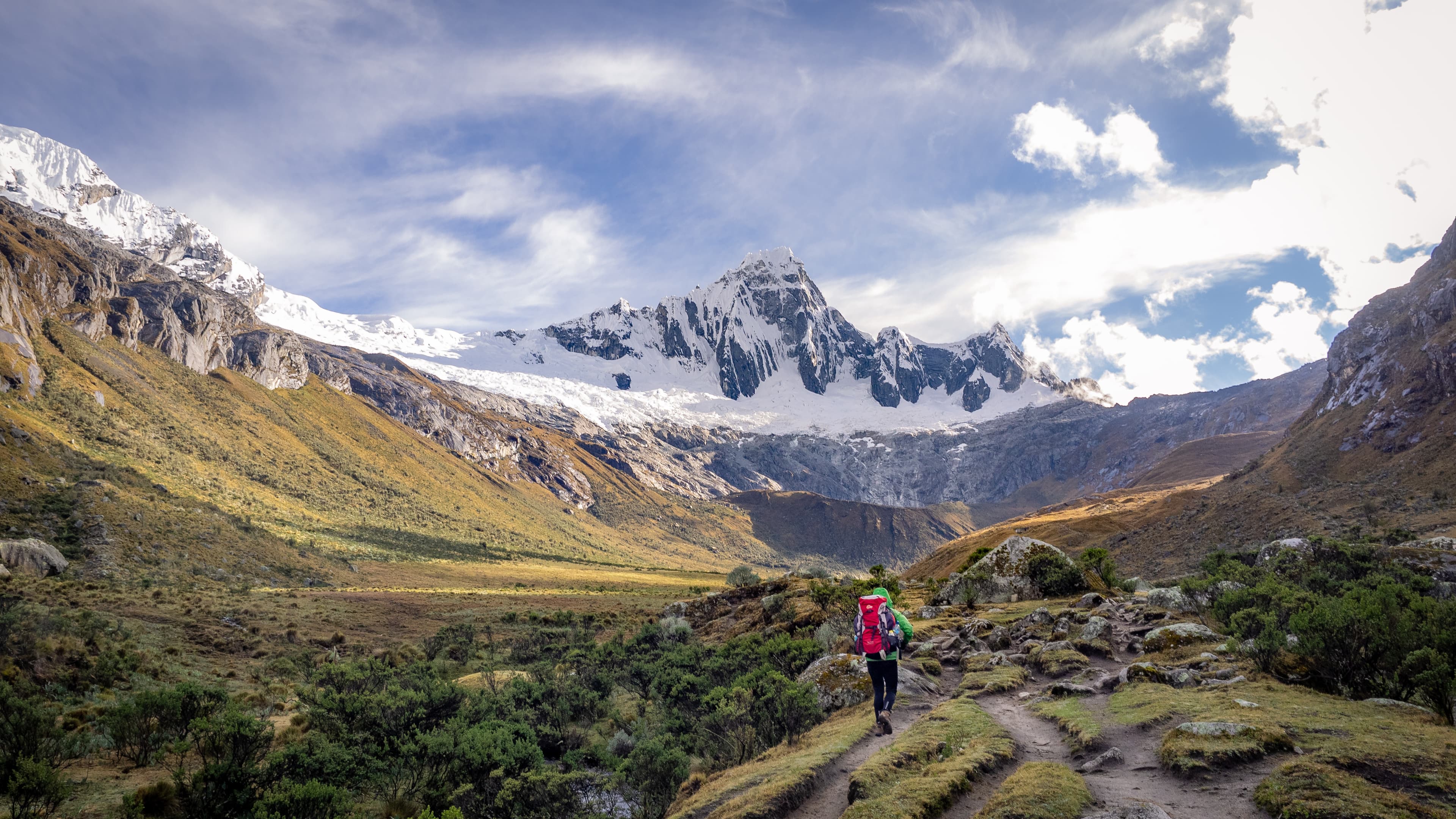 Trekking in the Cordillera Blanca in Peru on the Santa Cruz Trek with a view on Taulliraju on the way to Punta Union Trekking in the Cordillera Blanca in Peru
