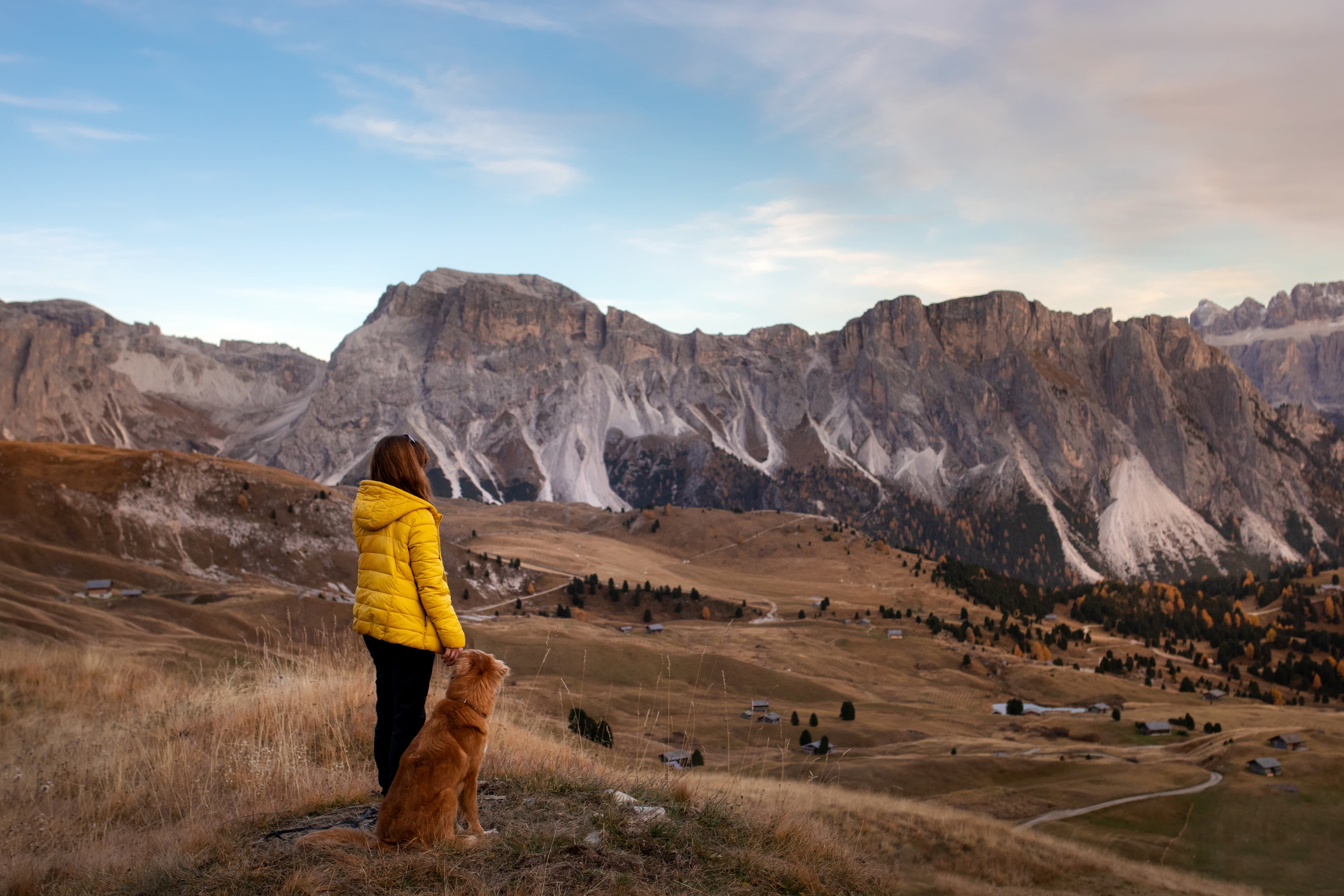 person with a dog in the mountains. travel, hiking with a pet. Nova Scotia Duck Tolling Retriever with a girl. Nova Scotia Region 15