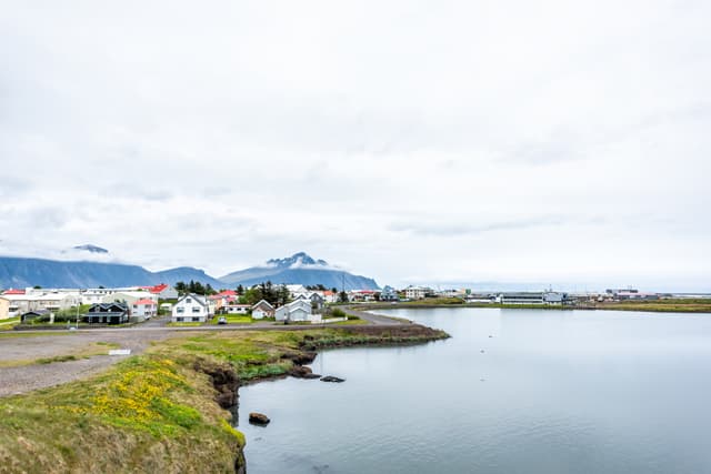 Landscape cityscape view of peaceful picturesque village by tranquil fjord water river and mountains in small fishing town called Hofn in Iceland cityscape Landscape cityscape view of peaceful picturesque village by tranquil fjord water river and mountains in small fishing town called Hofn in Iceland cityscape