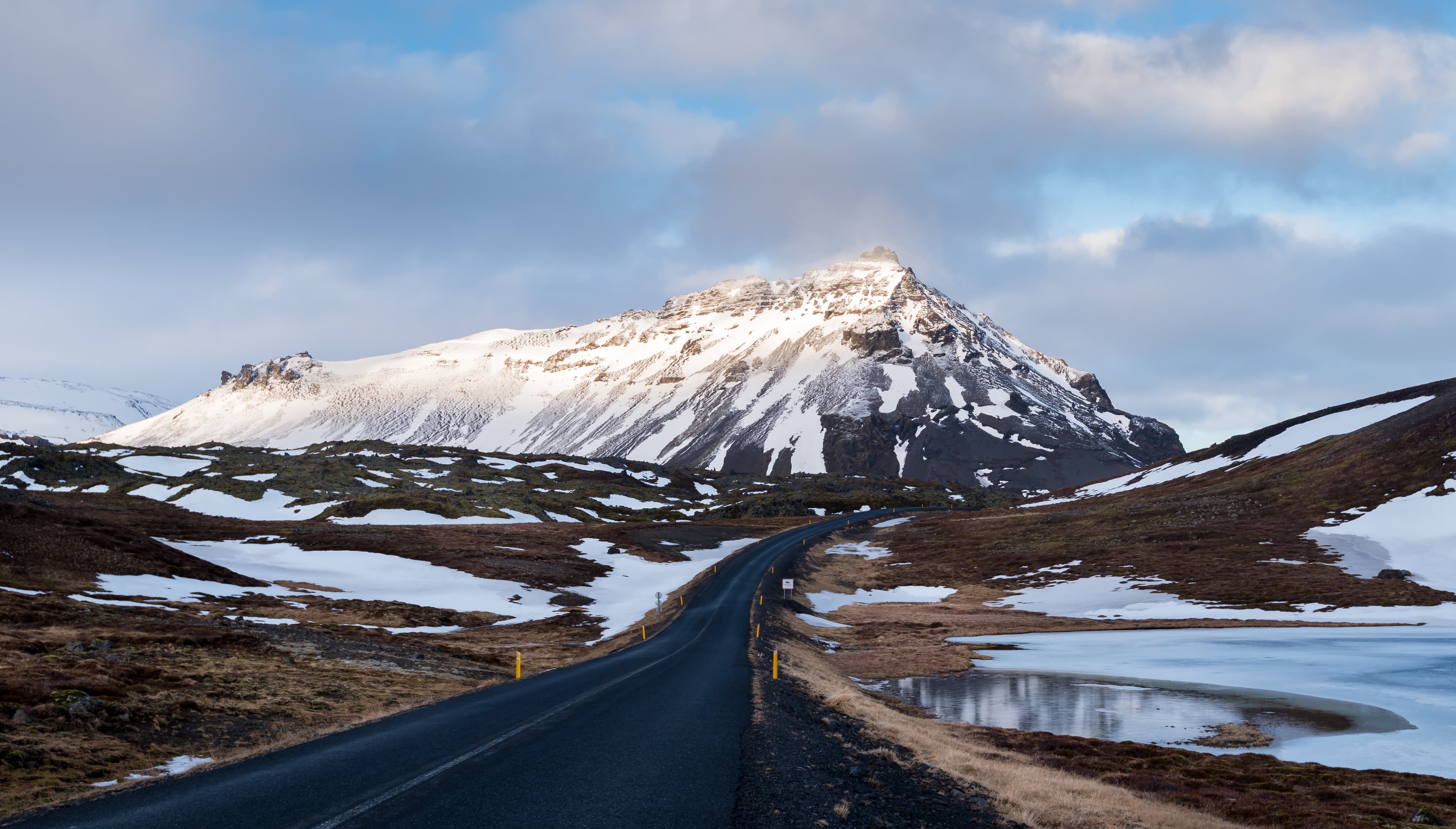 Typical Icelandic snowy nature mountain landscape and empty road near Arnarstapi area in Snaefellsnes peninsula in Iceland Icelandic snowy nature mountain landscape and empty road Iceland