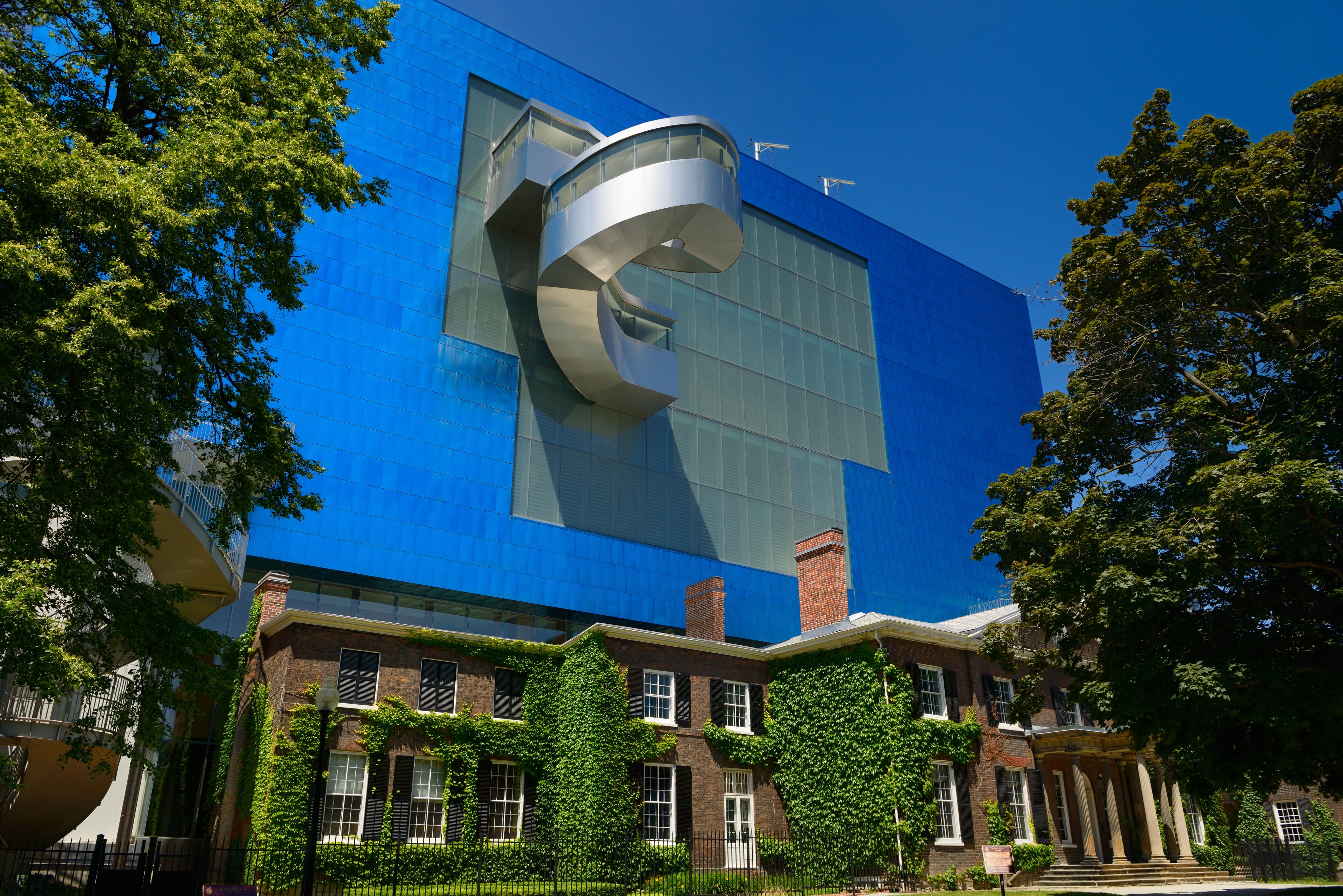 Blue titanium south wing of the Art Gallery of Ontario designed by Gehry over the historic Grange manor Toronto Blue titanium south wing of the Art Gallery of Ontario designed by Gehry over the historic Grange manor Toronto, Canada - June 19, 2014