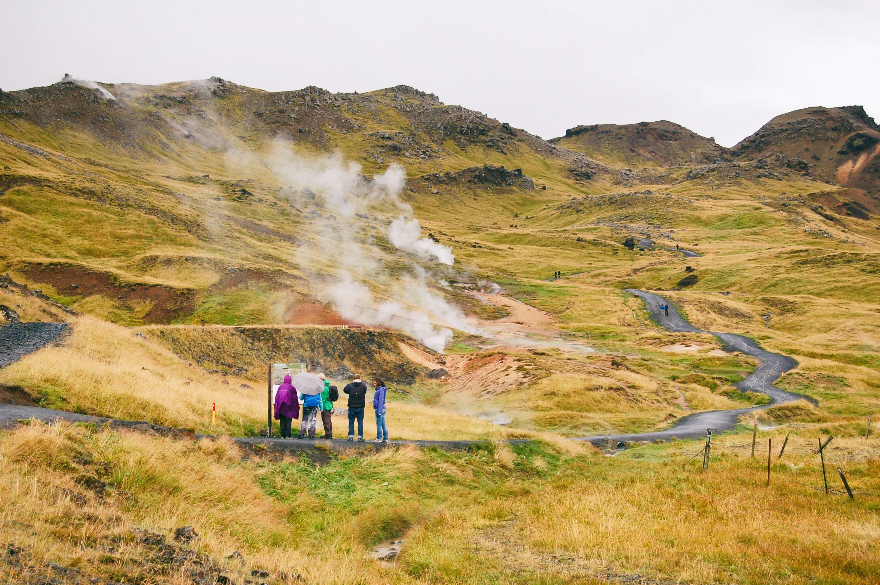 Tourist at the beginning of Reykjadalur valley path Tourist at the beginning of Reykjadalur valley path