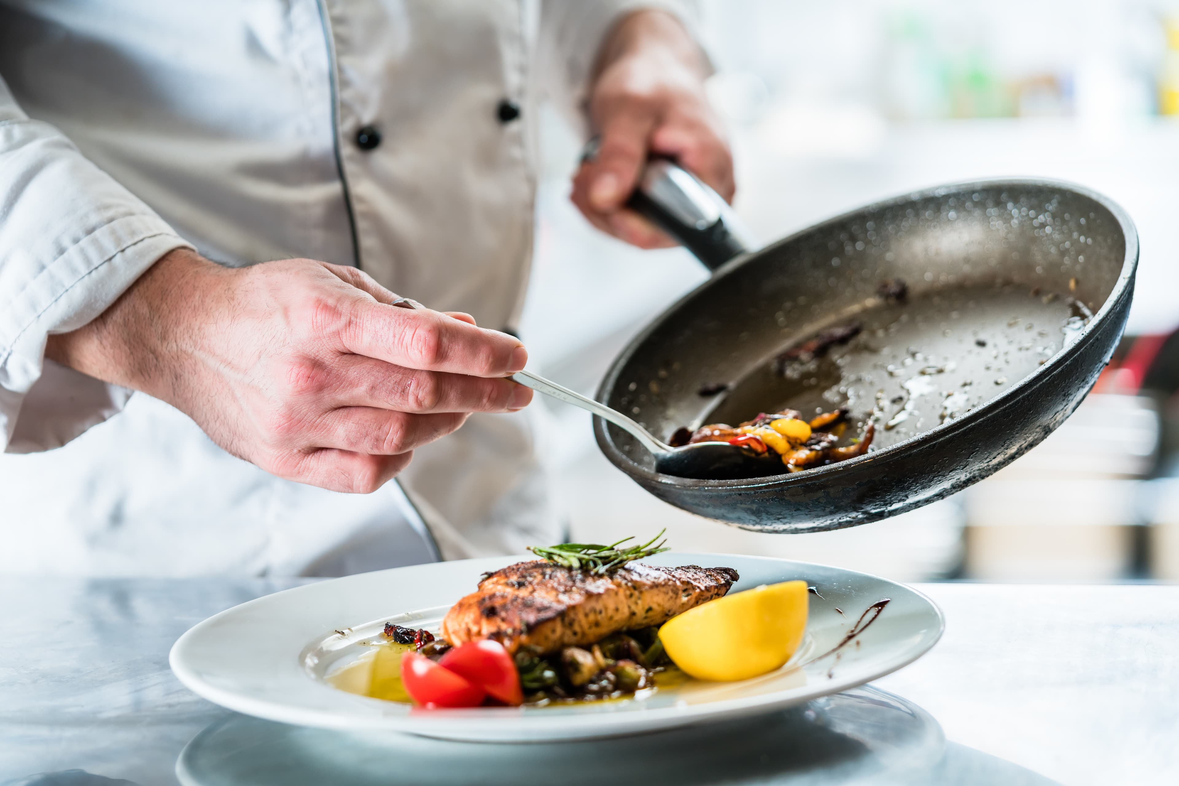 Chef finishing food in his restaurant kitchen British Columbia Region 10