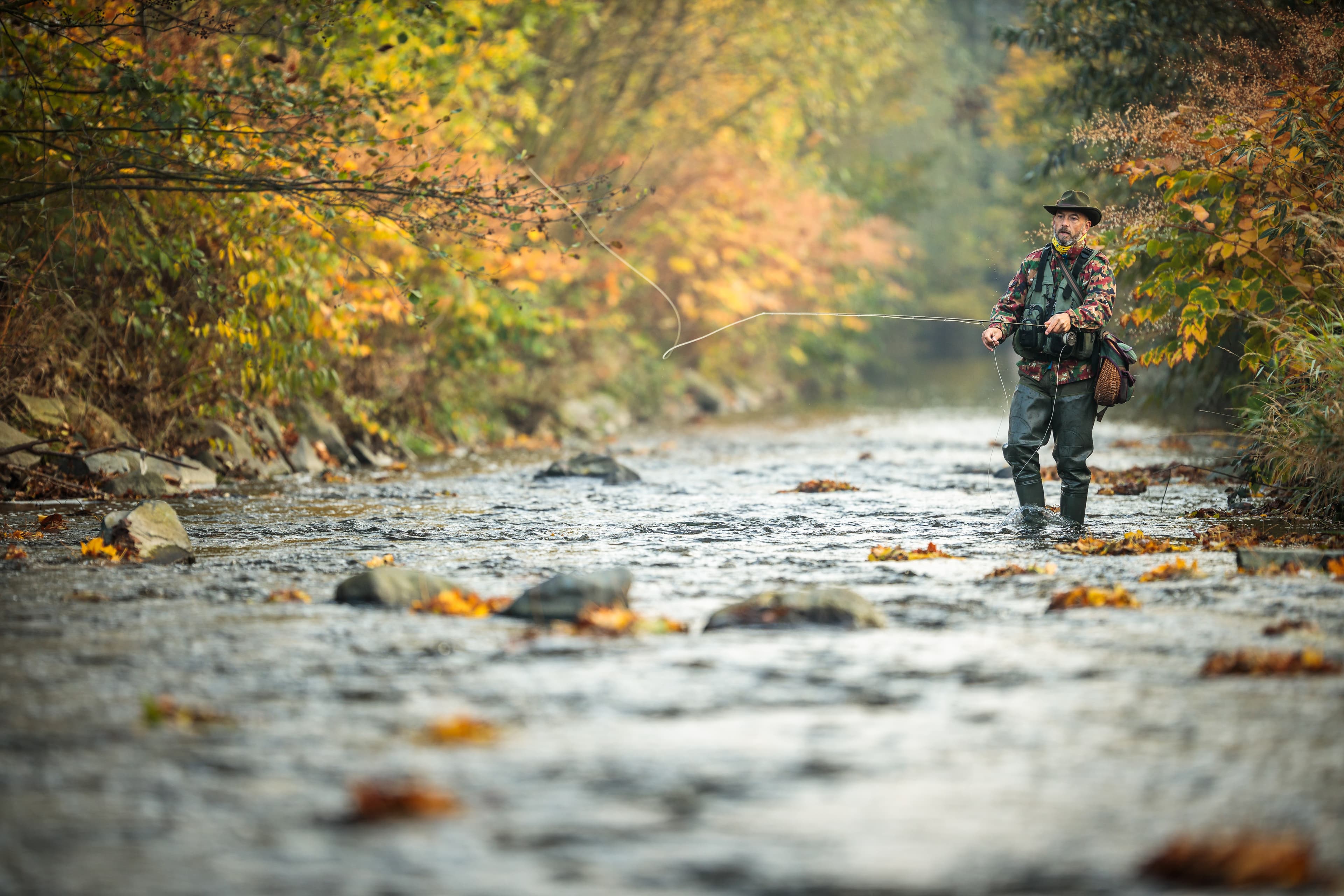 Fly fisherman fly fishing on a splendid mountain river Fly fisherman fly fishing on a splendid mountain river