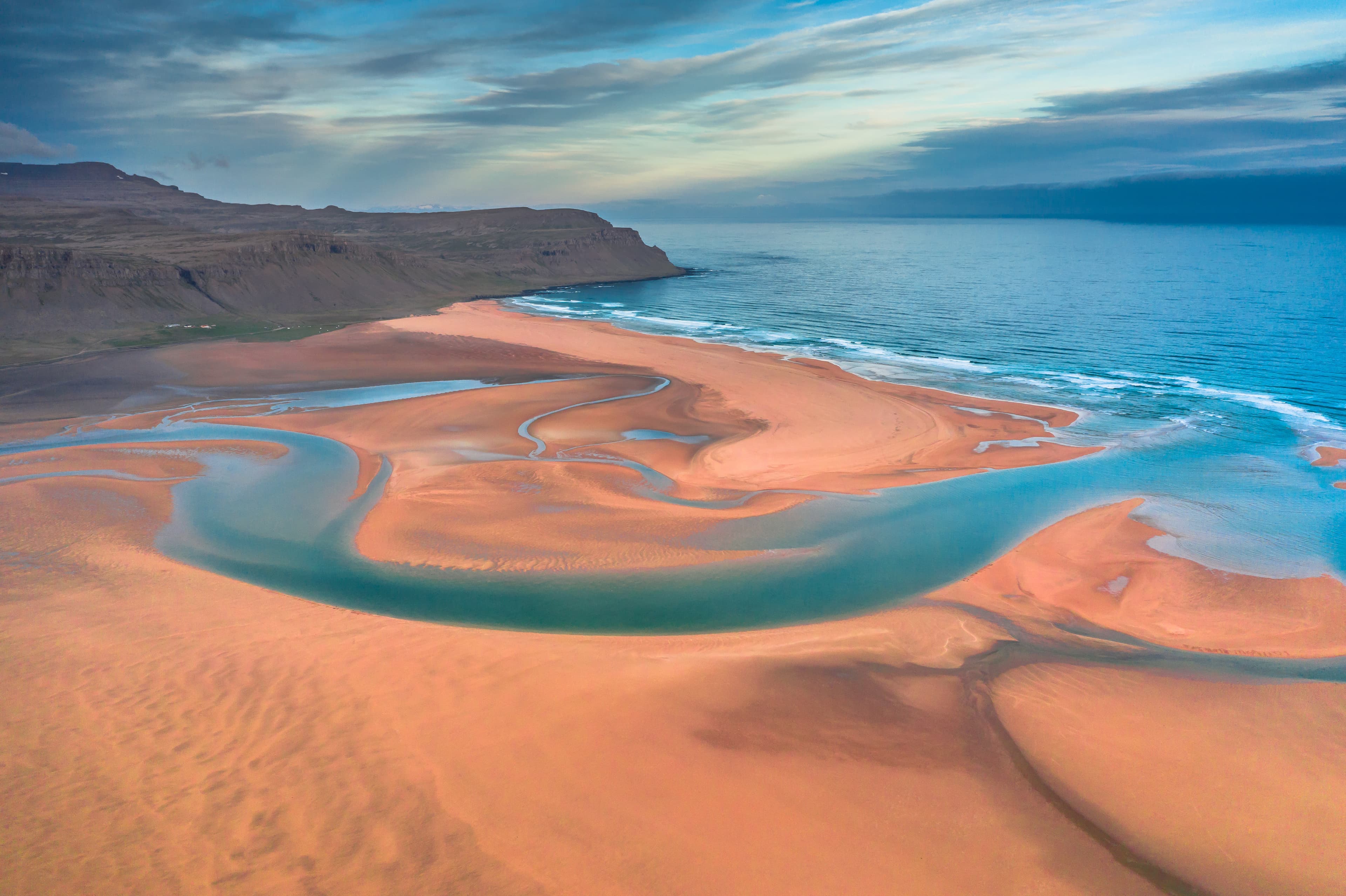 Aerial view of Raudasandur beach at the west fjords of Iceland Aerial drone view of icelandic Raudasandur beach with azure water streams and yellow sand