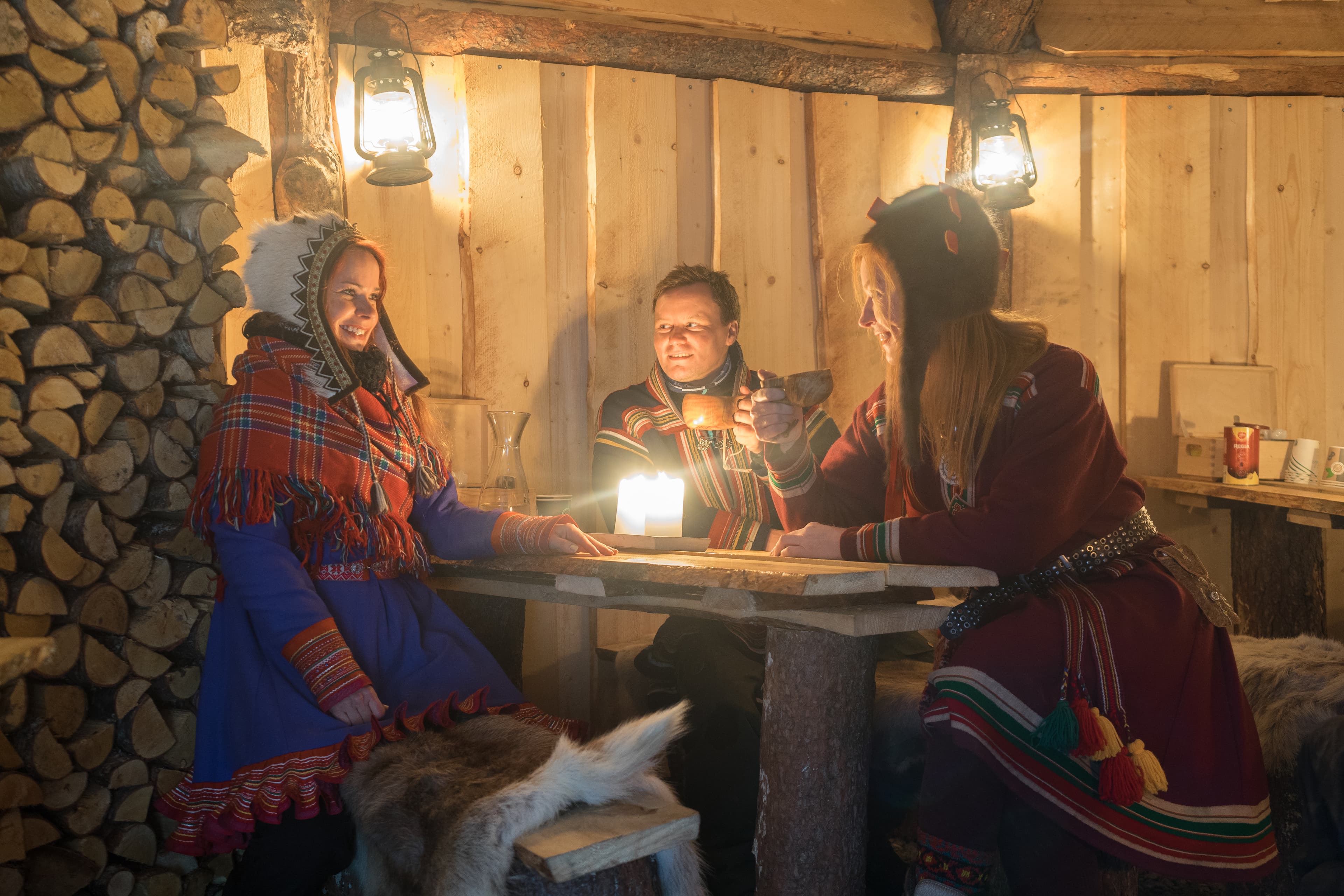 Family-wearing-traditional-clothing-in-wooden-cabin