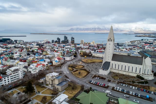 Aerial view of famous Hallgrimskirkja Cathedral and the city of Reykjavik in Iceland. Image taken with action drone camera Aerial view of famous Hallgrimskirkja Cathedral and the city of Reykjavik in Iceland
