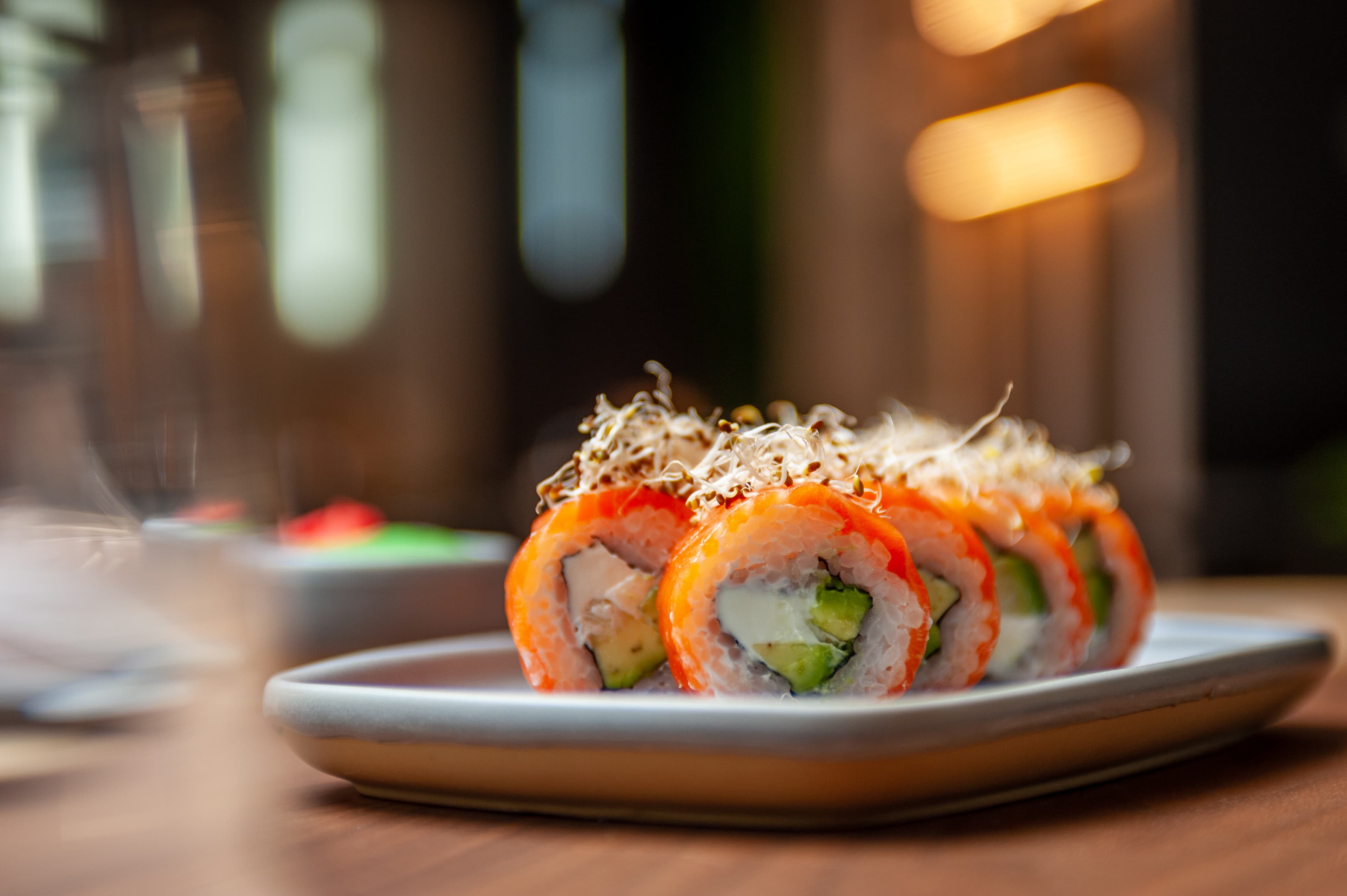 Classic Philadelphia sushi roll set with salmon and cream cheese. Japanese dish of fresh salmon and rice. High quality photo Classic Philadelphia sushi roll set with salmon and cream cheese.