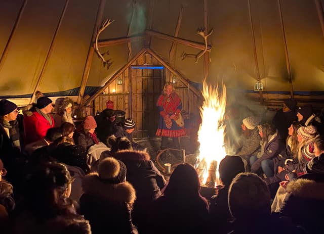 People-sitting-by-the-fire-in-wooden-cabin
