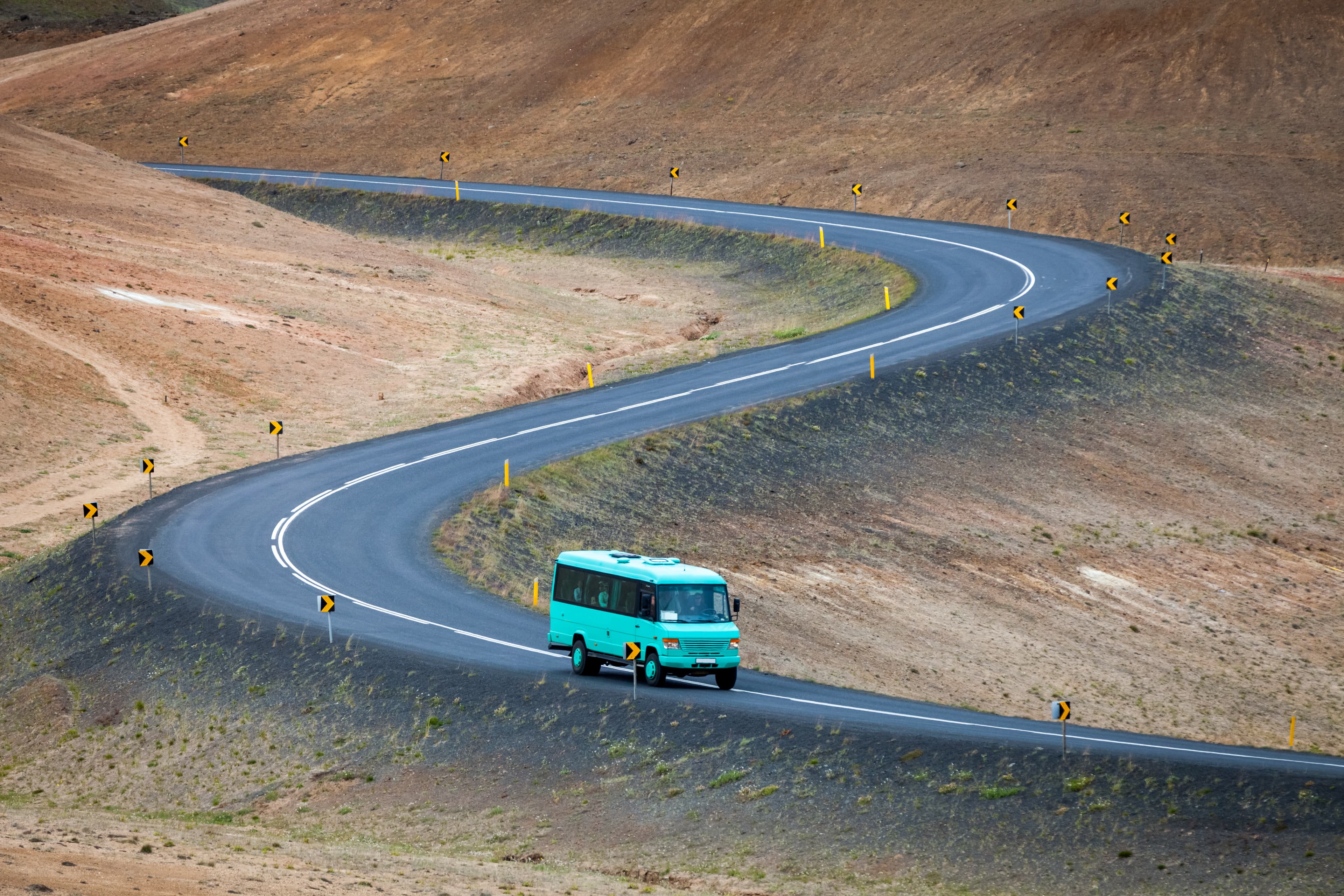 Bus with tourists on Ring road near Myvatn lake, Iceland Bus with tourists on Ring road near Myvatn lake, Iceland
