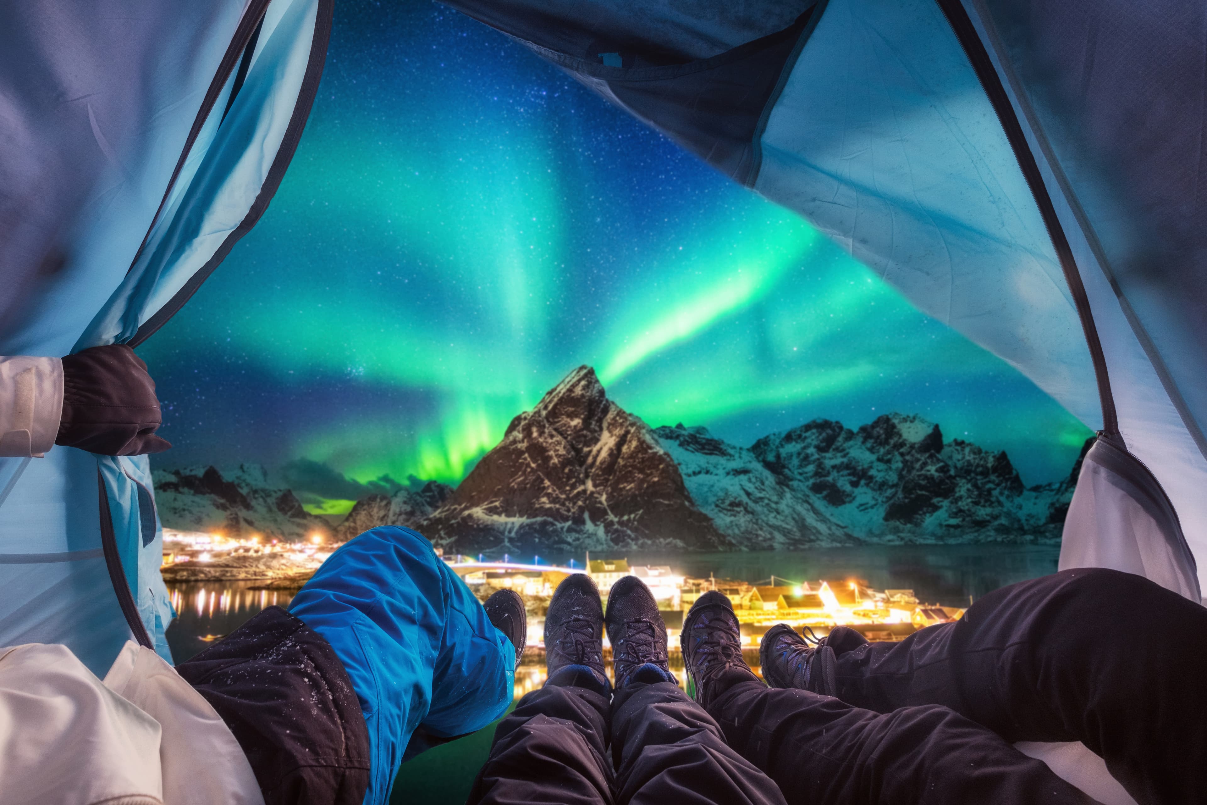 Group of climber are inside camping with aurora borealis over mountain at Sakrisoy village Group of climber are inside camping with aurora borealis over mountain