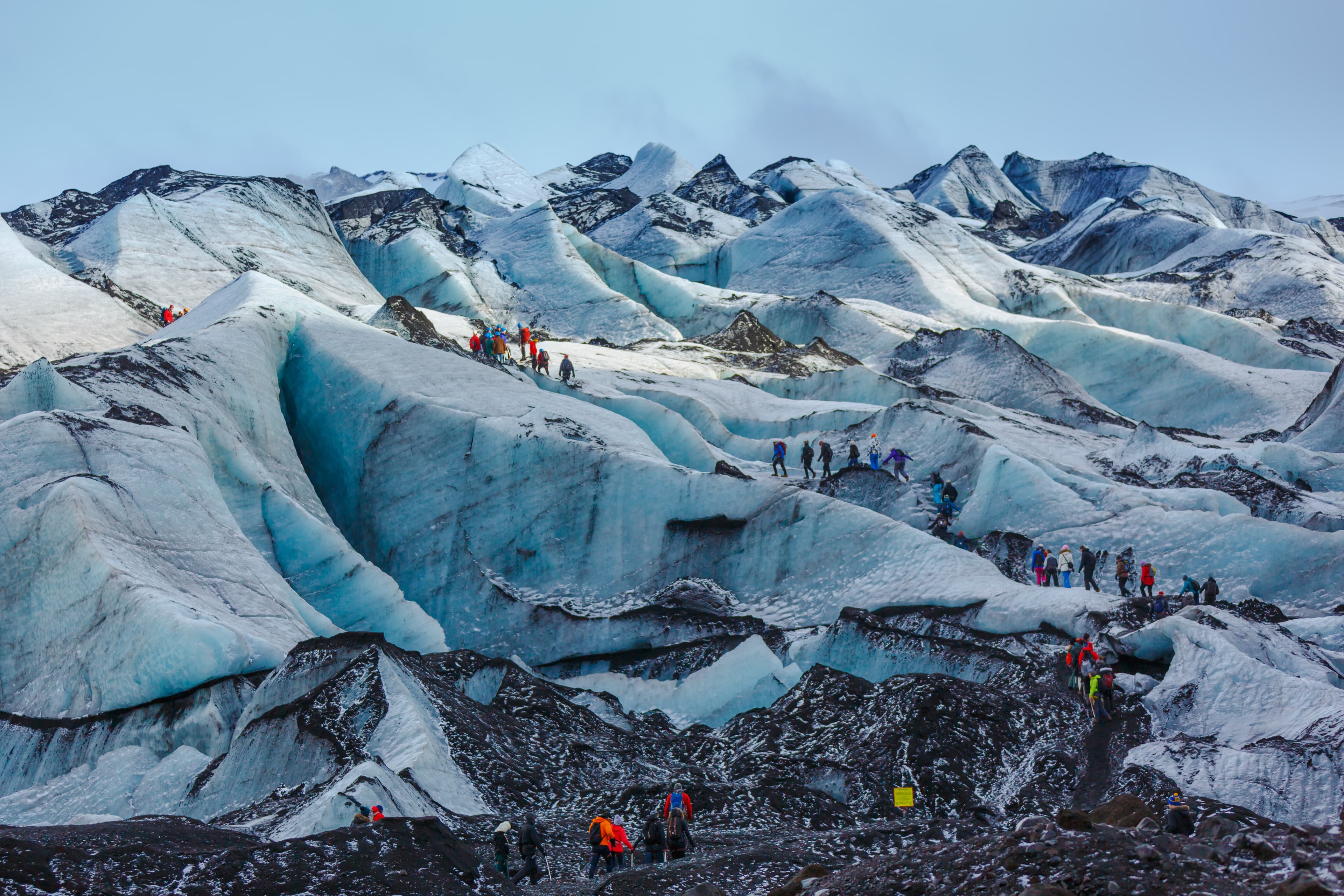 Private guide and group of hiker walking on glacier at Solheimajokull, Iceland Private guide and group of hiker walking on glacier at Solheimajokull