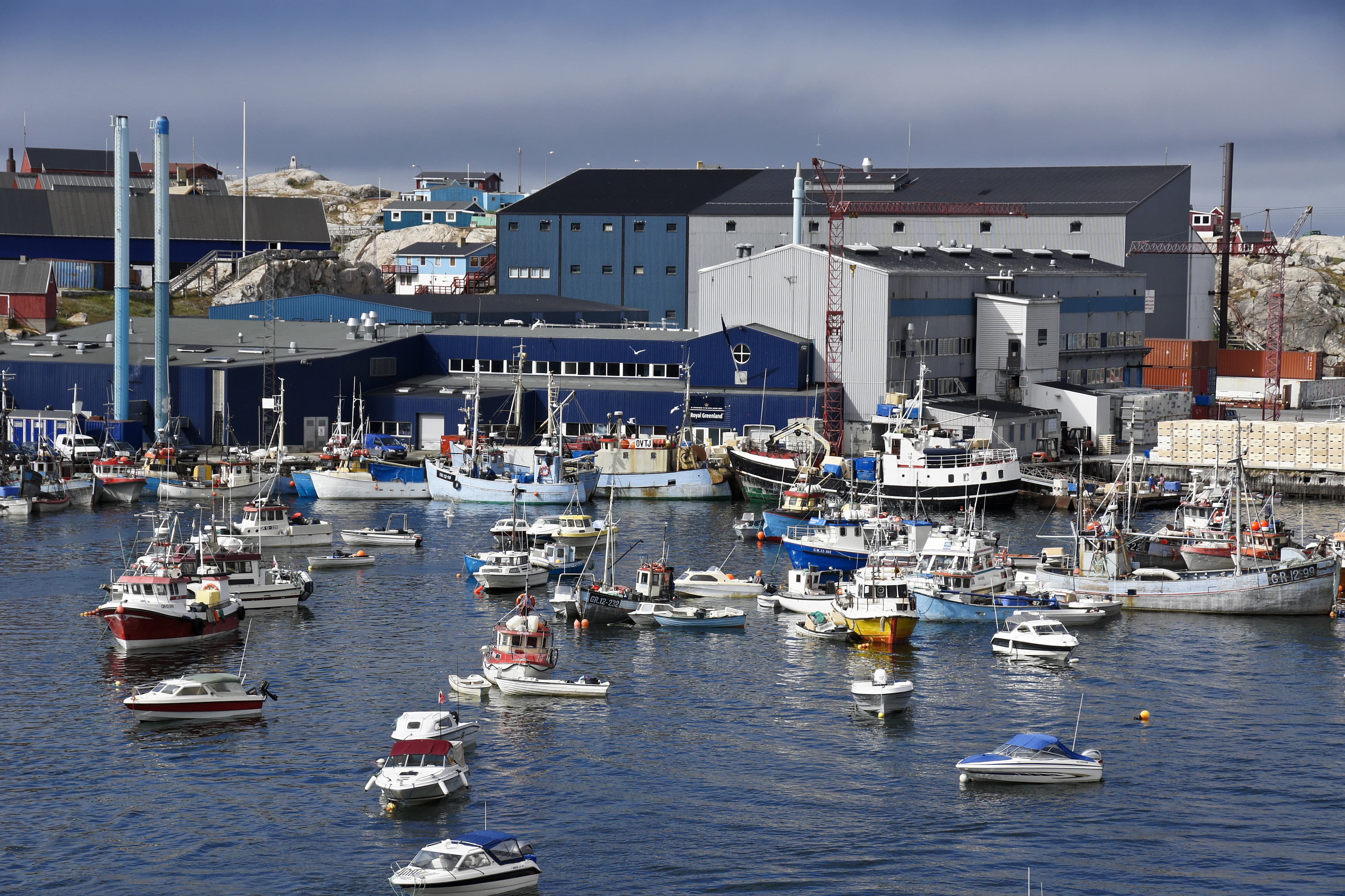 ILULISSAT, WEST GREENLAND, JULY 27, 2013. Fishing boats of all sizes crowd the tiny harbor in Ilulissat, West Greenland. Fishing boats of all sizes crowd the tiny harbor in Ilulissat, West Greenland.