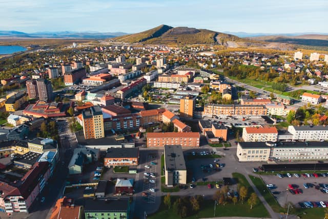 Aerial summer sunny view of Kiruna, the northernmost town in Sweden, province of Lapland, Norrbotten County, picture shot from drone
 Aerial summer sunny view of Kiruna, the northernmost town in Sweden, province of Lapland, Norrbotten County, picture shot from drone
