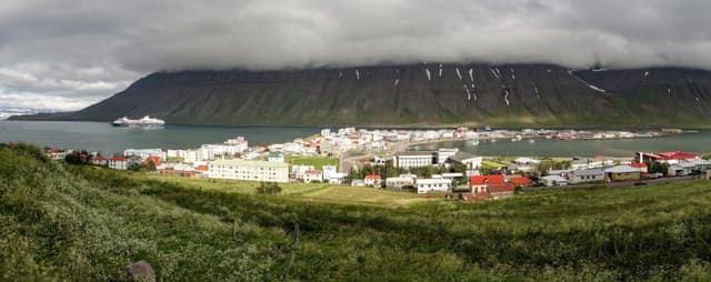 Wide-angle panorama of the Isafjordur city in Iceland with storm and fog coming Wide-angle panorama of the Isafjordur city in Iceland with storm and fog