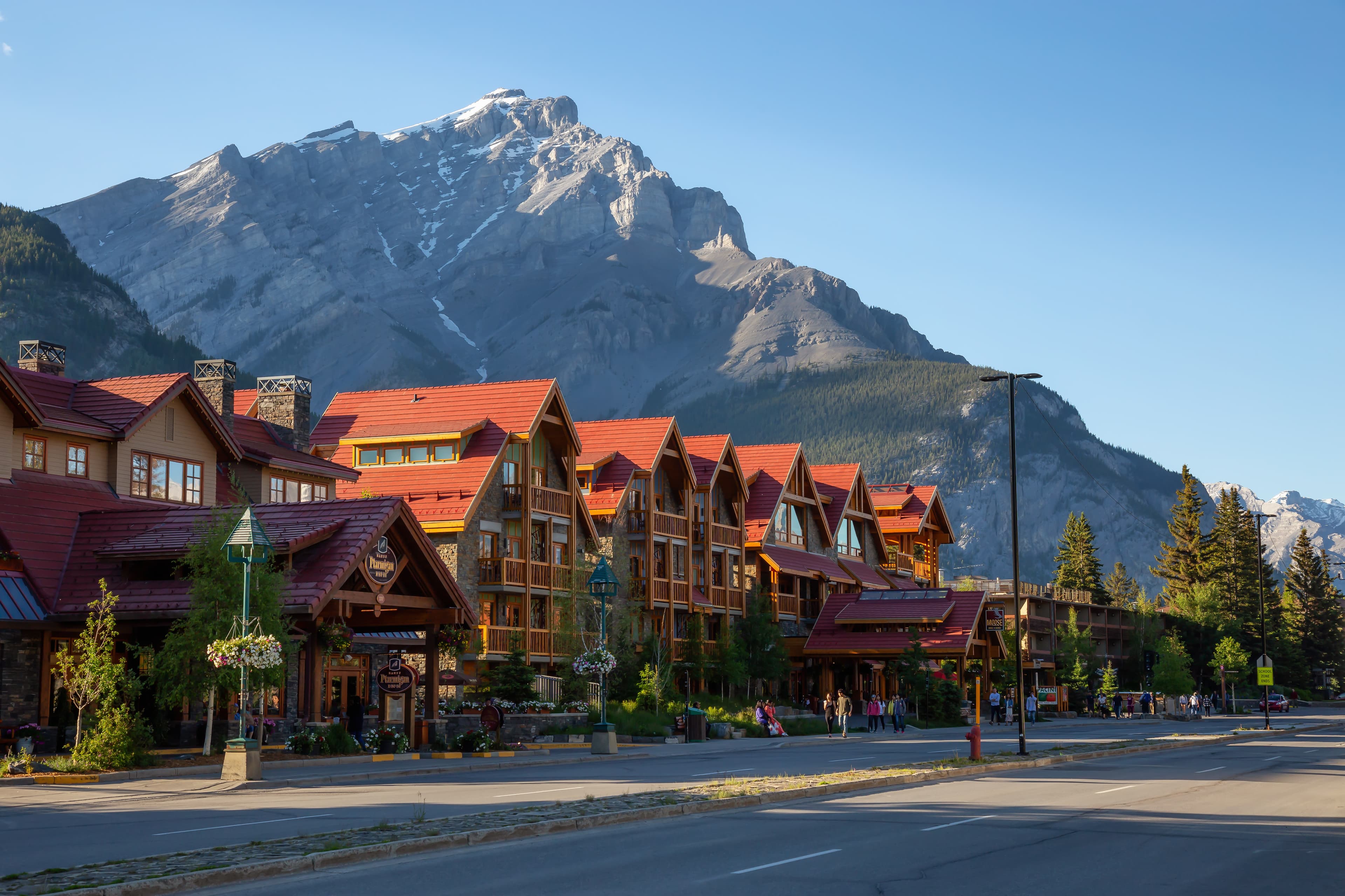 Banff, Alberta, Canada - June 17, 2018: Beautiful view of Banff City during a vibrant summer day. Banff, Alberta, Canada - June 17, 2018: Beautiful view of Banff City during a vibrant summer day.