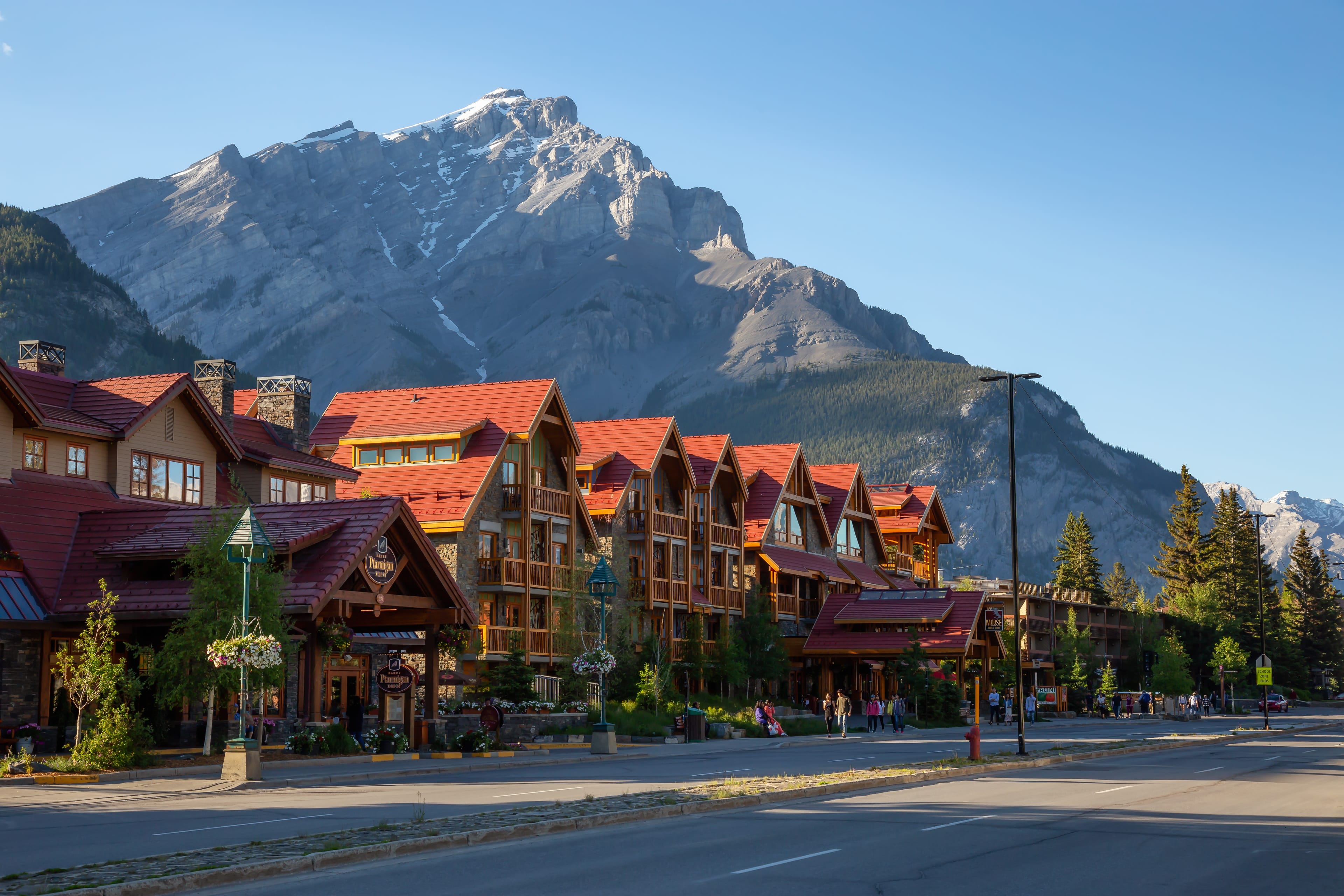 Banff, Alberta, Canada - June 17, 2018: Beautiful view of Banff City during a vibrant summer day. Banff, Alberta, Canada - June 17, 2018: Beautiful view of Banff City during a vibrant summer day.