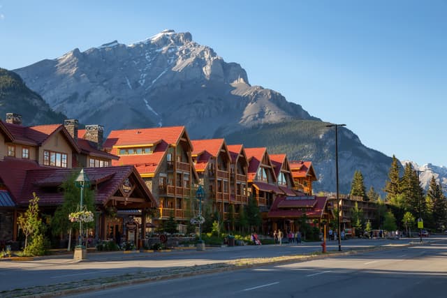 Banff, Alberta, Canada - June 17, 2018: Beautiful view of Banff City during a vibrant summer day. Banff, Alberta, Canada - June 17, 2018: Beautiful view of Banff City during a vibrant summer day.