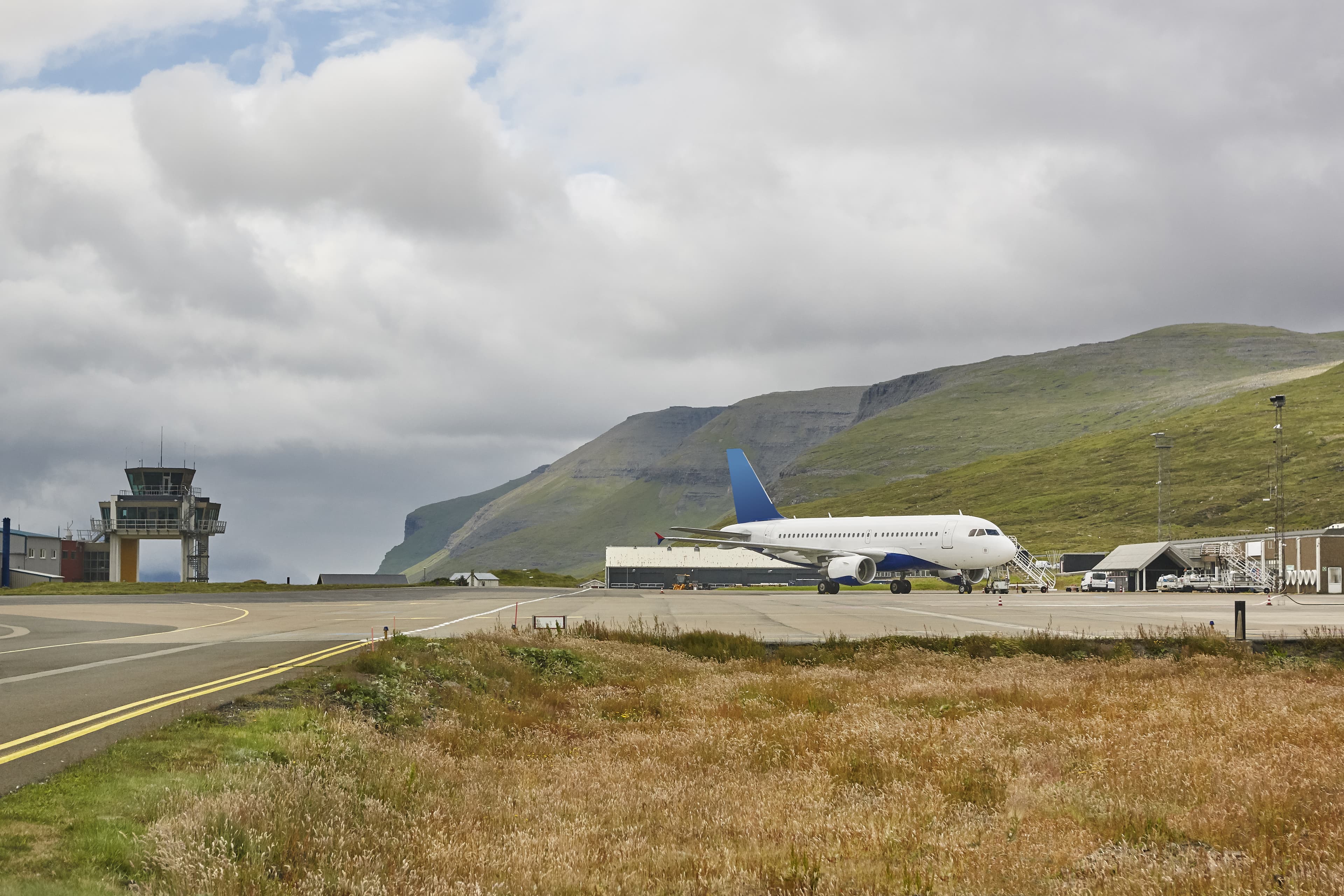 Faroe islands airport runway and control tower with airplane. Travel Faroe islands airport runway and control tower with airplane.