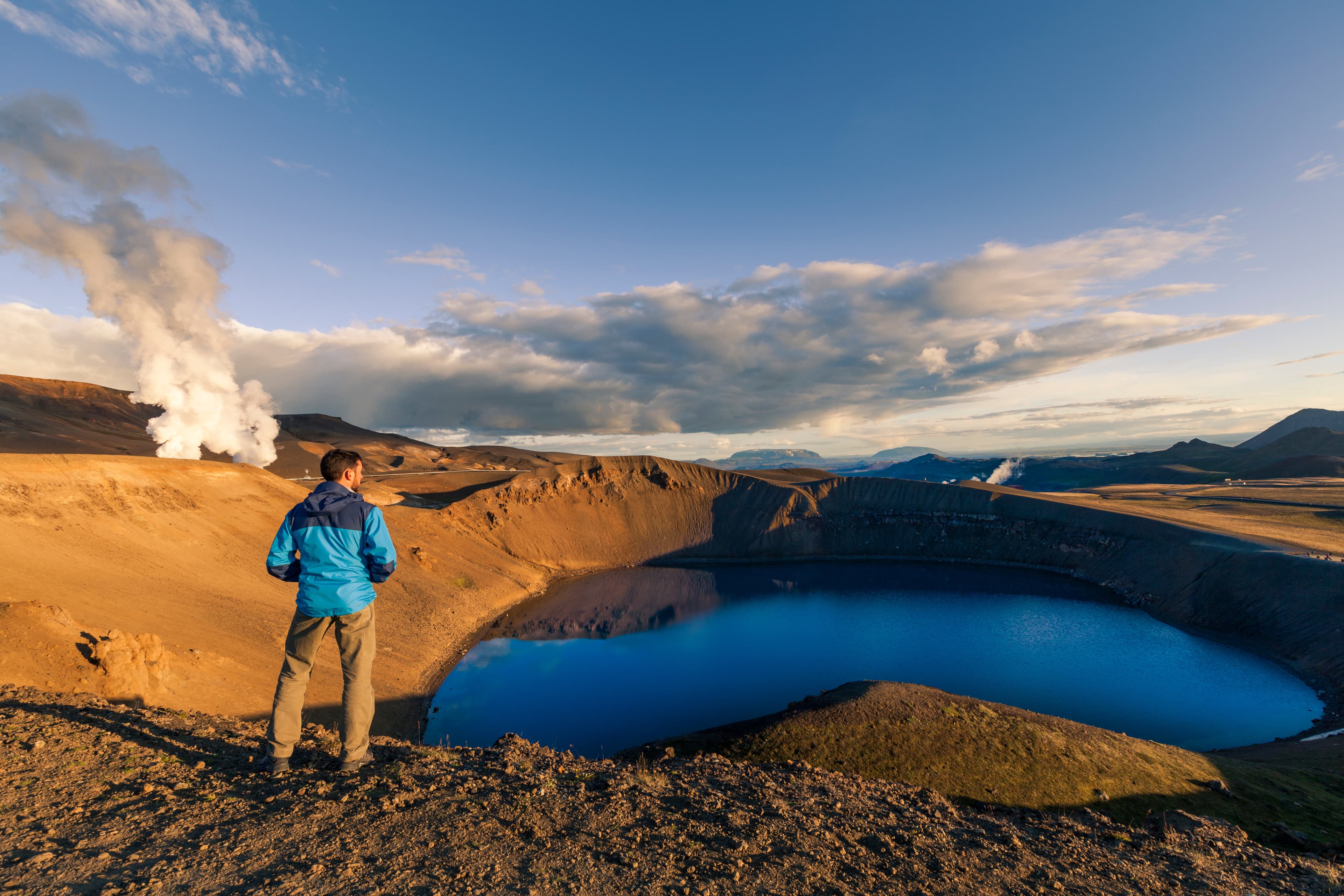 Explorer overlooking Viti crater near Krafla lava fields, Iceland Explorer overlooking Viti crater near Krafla lava fields