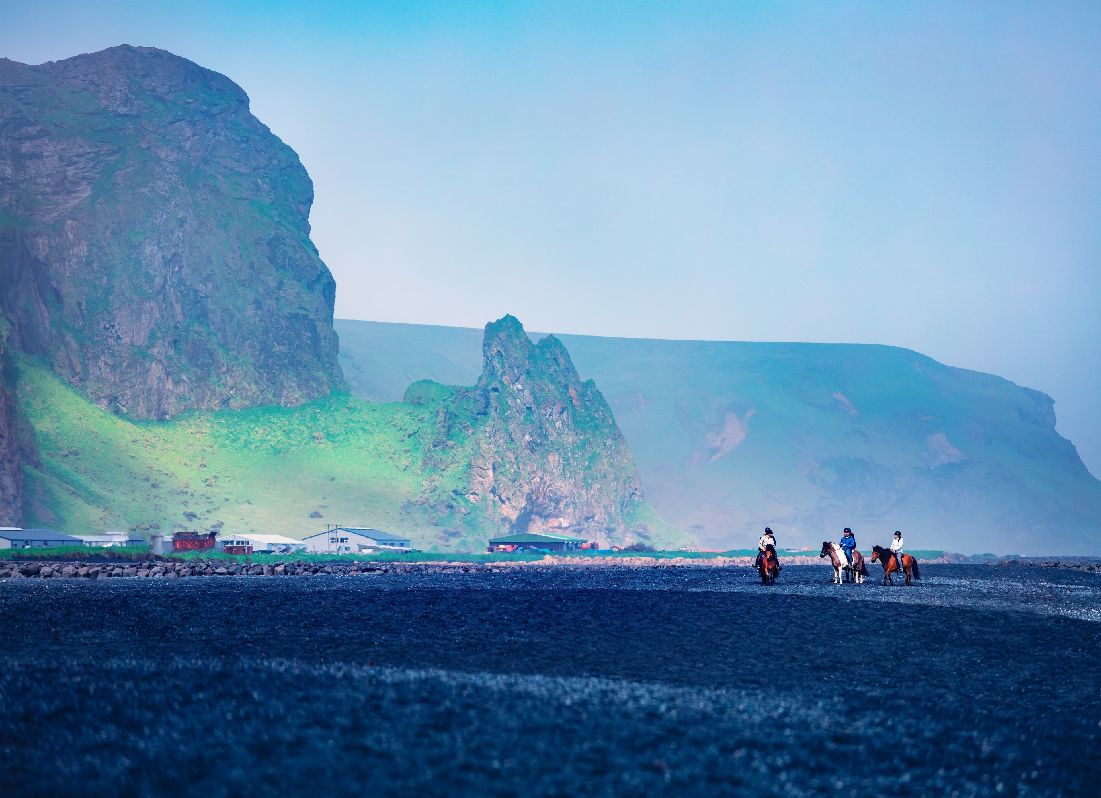 Horseback riding on the famous Black Sand Beach in Vik village. Amazing summer scene of Icelan, Europe. Traveling concept background.. Horseback riding on the famous Black Sand Beach in Vik village. Amazing summer scene of Icelan, Europe. Traveling concept background..