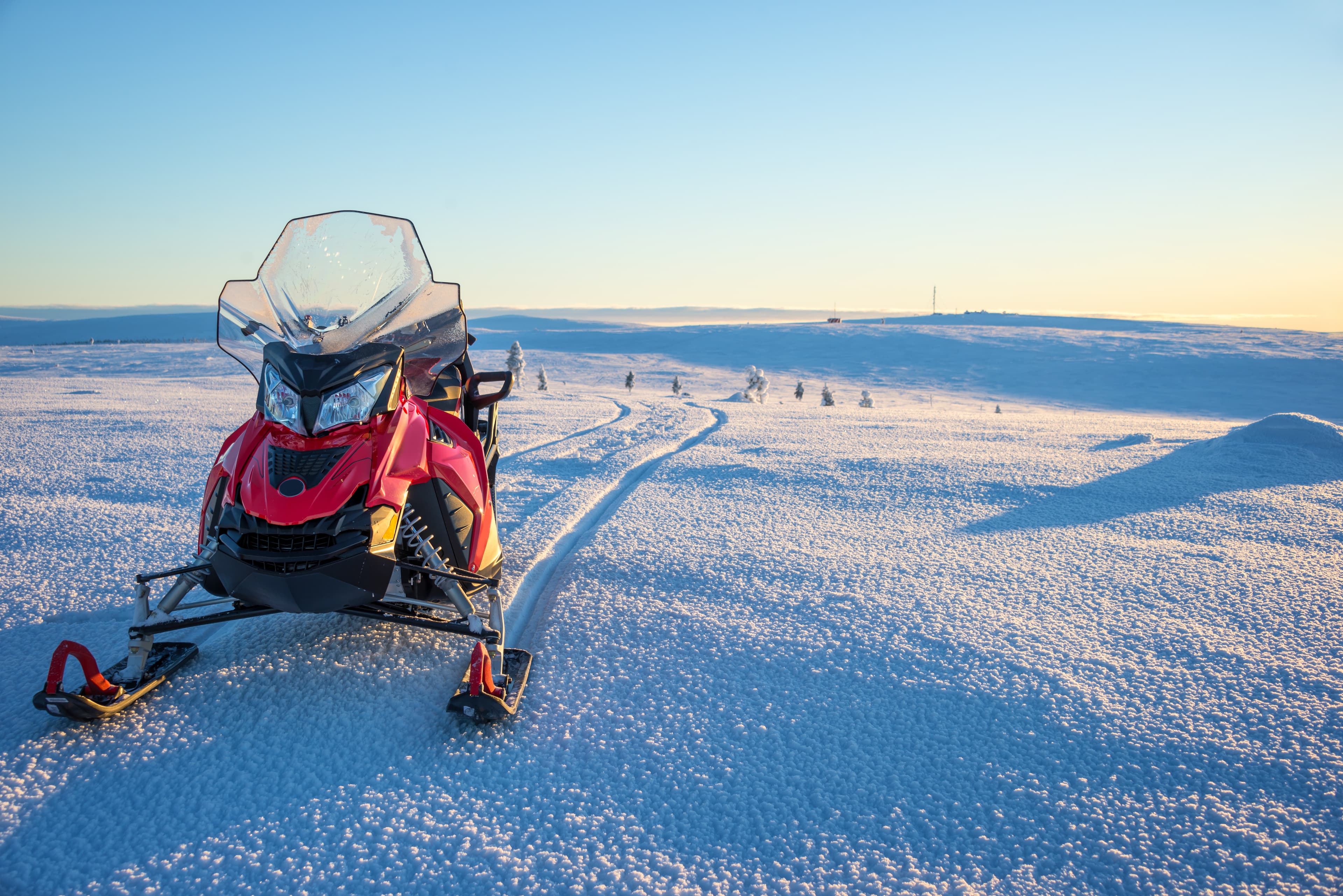 Snowmobile in a snowy landscape in Lapland, near Saariselka, Finland Snowmobile in a snowy landscape in Lapland, near Saariselka, Finland