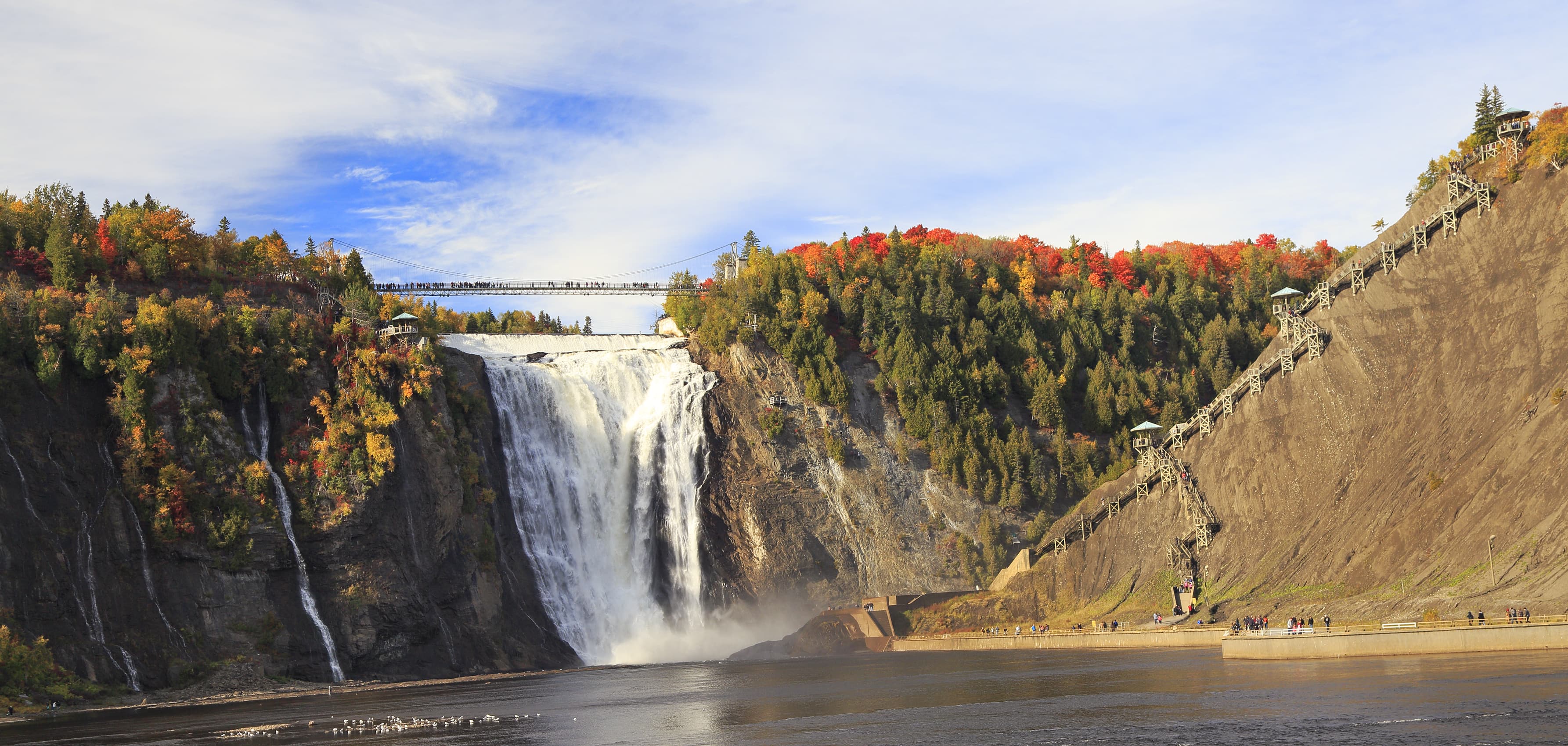 Montmorency Falls and Bridge in autumn with colorful trees, Quebec, Canada