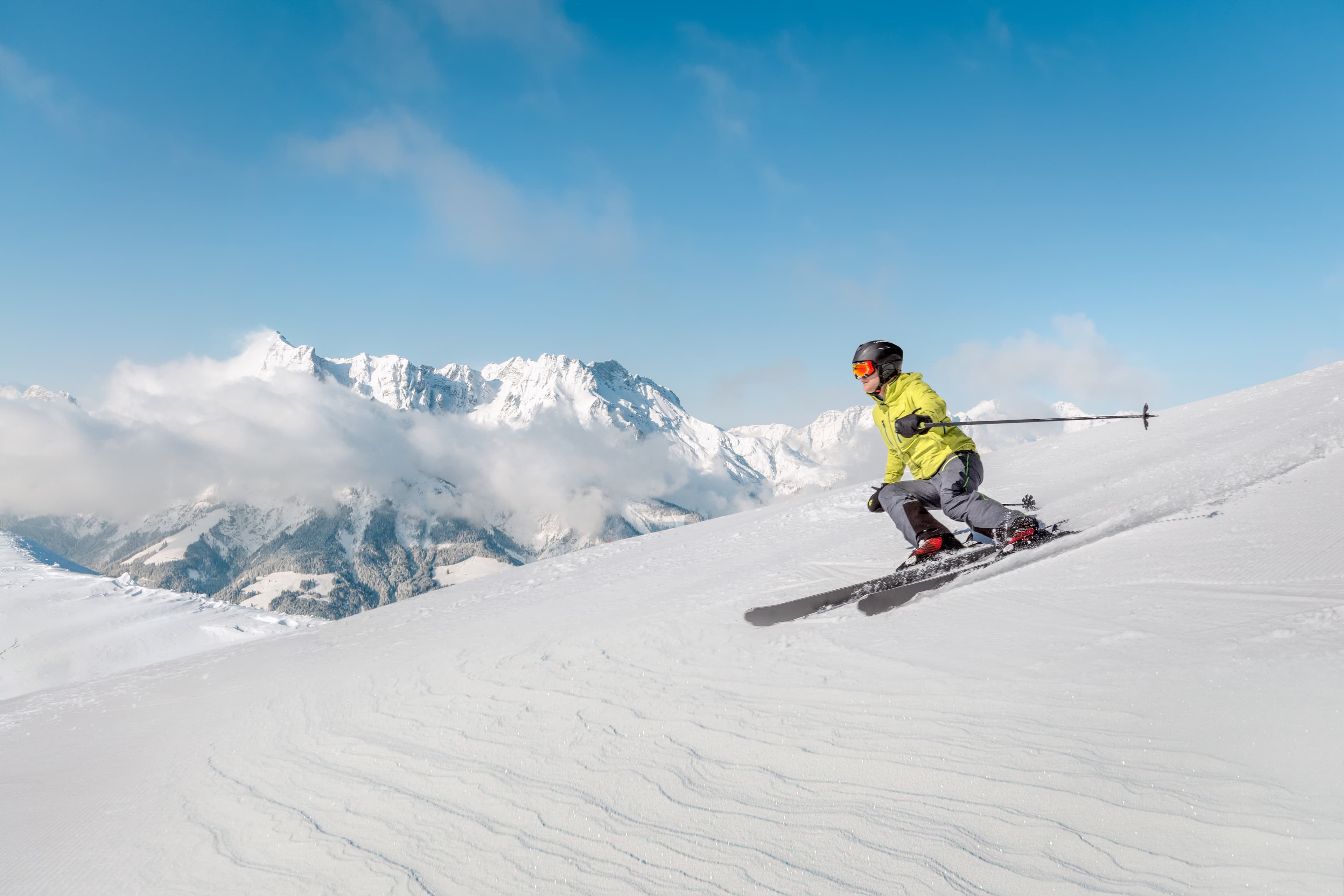 Alpine skier with snowy mountains British Columbia Region 12
