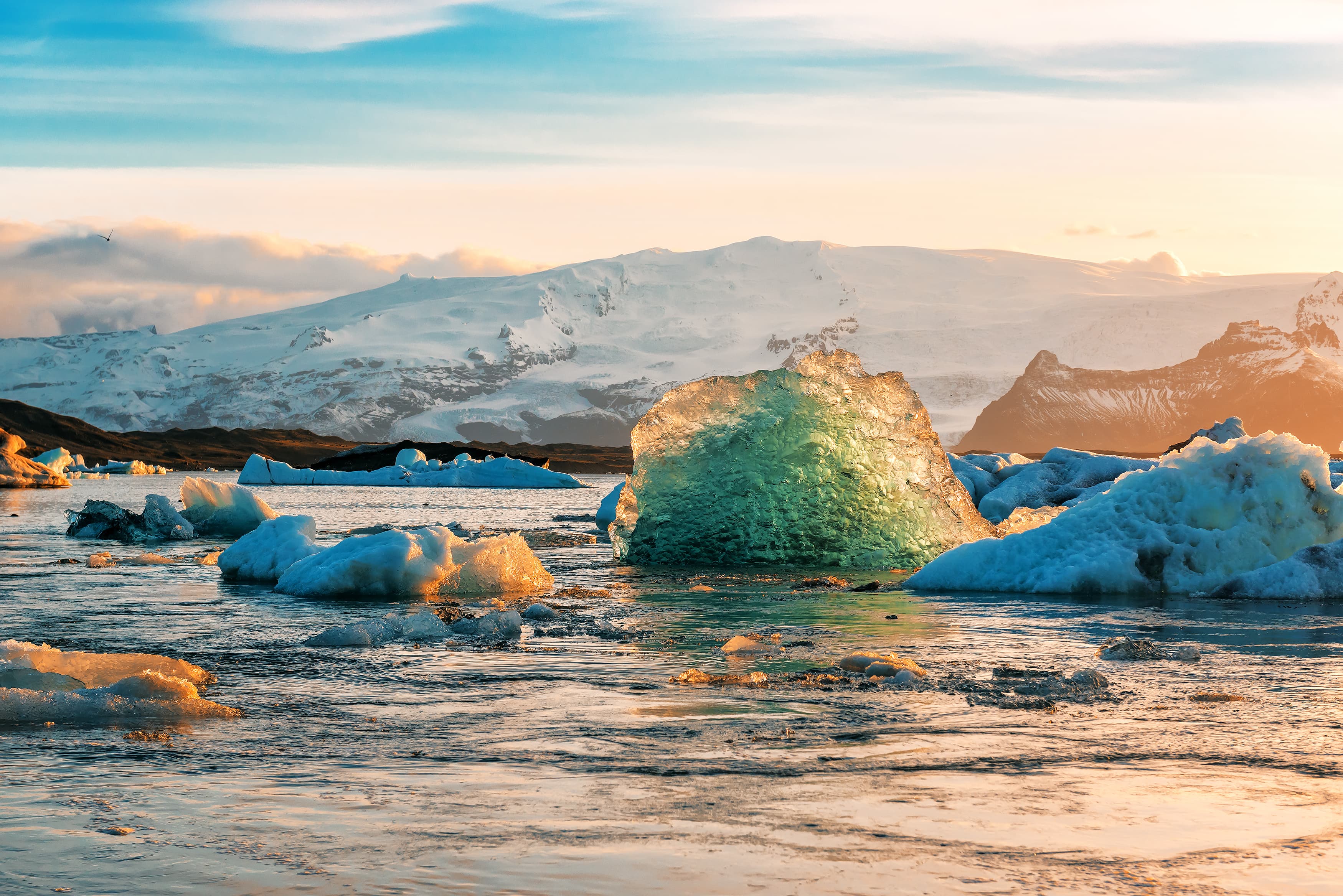 blue iceberg in ice lagoon at Iceland on sunset jokursalron-glacier-lagoon-winter-iceland