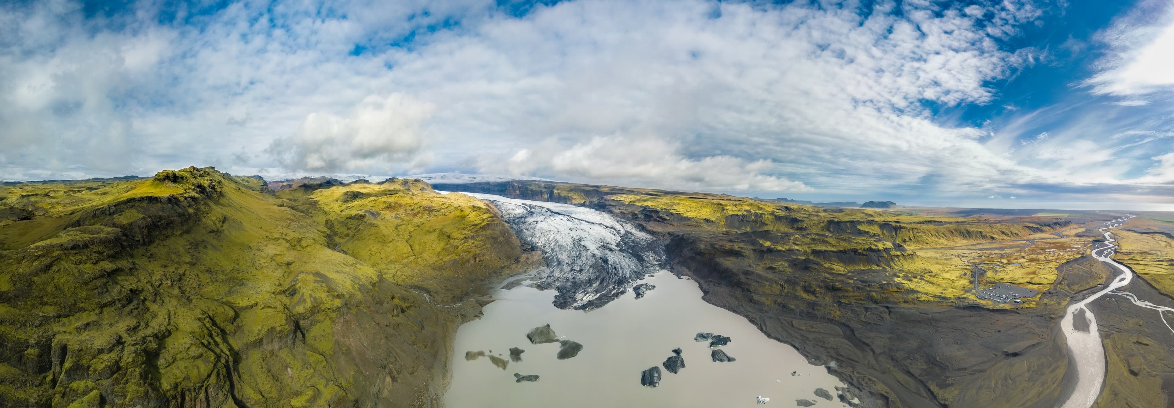 Aerial panoramic landscape view of a glacier and its lagoon in south Iceland